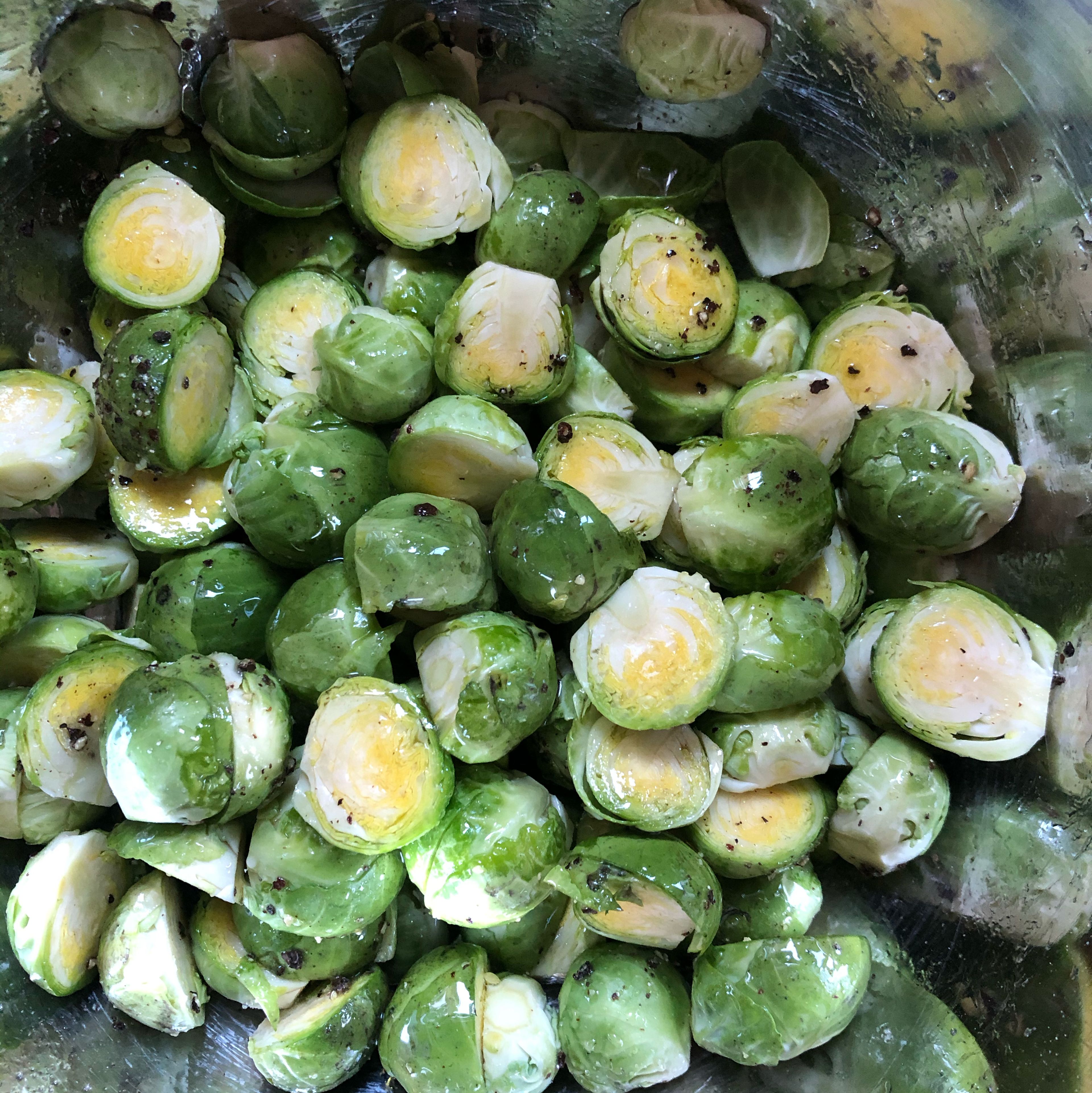 Cut sprouts in half, drizzle oil, salt, pepper and agave sirup /honey and mix up