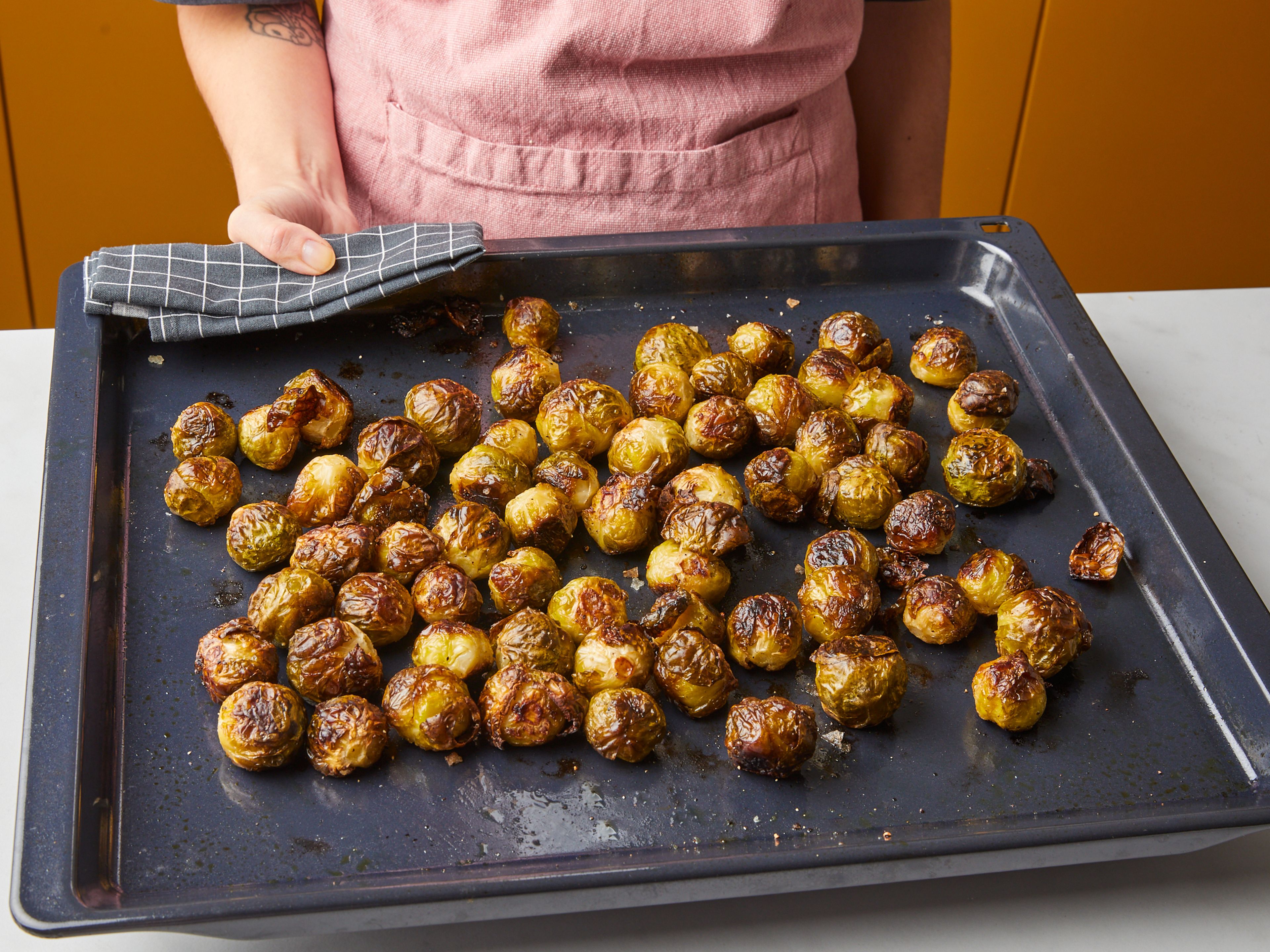 Roast brussels sprouts for approx. 15 min. Carefully shake the baking sheet to move the sprouts around and continue to roast for approx. 10 min. more. Shake baking sheet again, reduce oven temperature to 175°C/350°F, and roast approx. 15 min. more. The Brussels sprouts should be crispy and deeply browned all over, and a paring knife should slide through the center of the sprout easily. If not, roast in 5 min. intervals until tender, then remove from the oven and set aside.