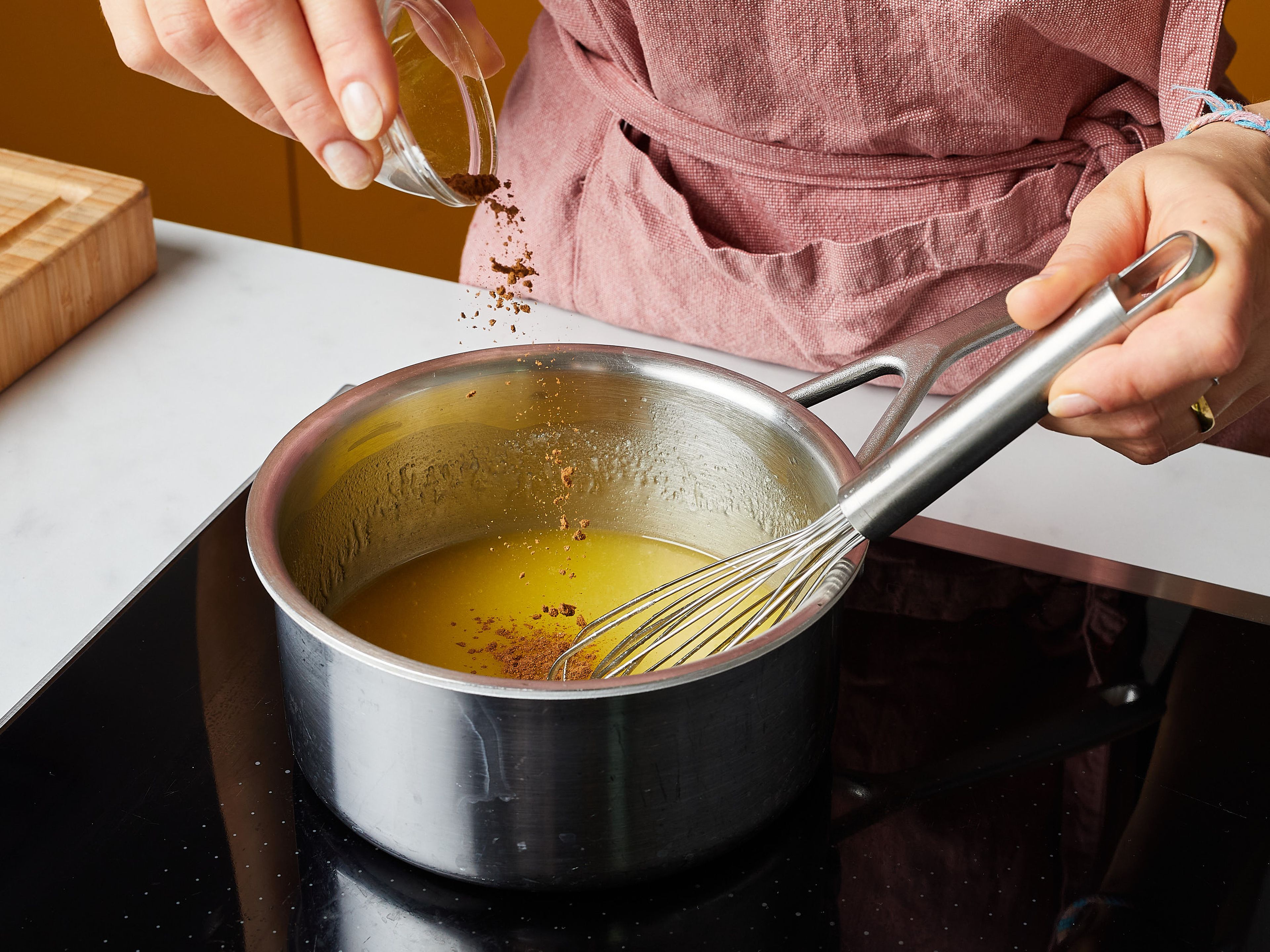 In the meantime, stir together the icing. Put the butter, remaining sugar, vanilla sugar, remaining milk, and cinnamon in a small saucepan, and heat over medium-low heat. Whisk until the sugar has dissolved.