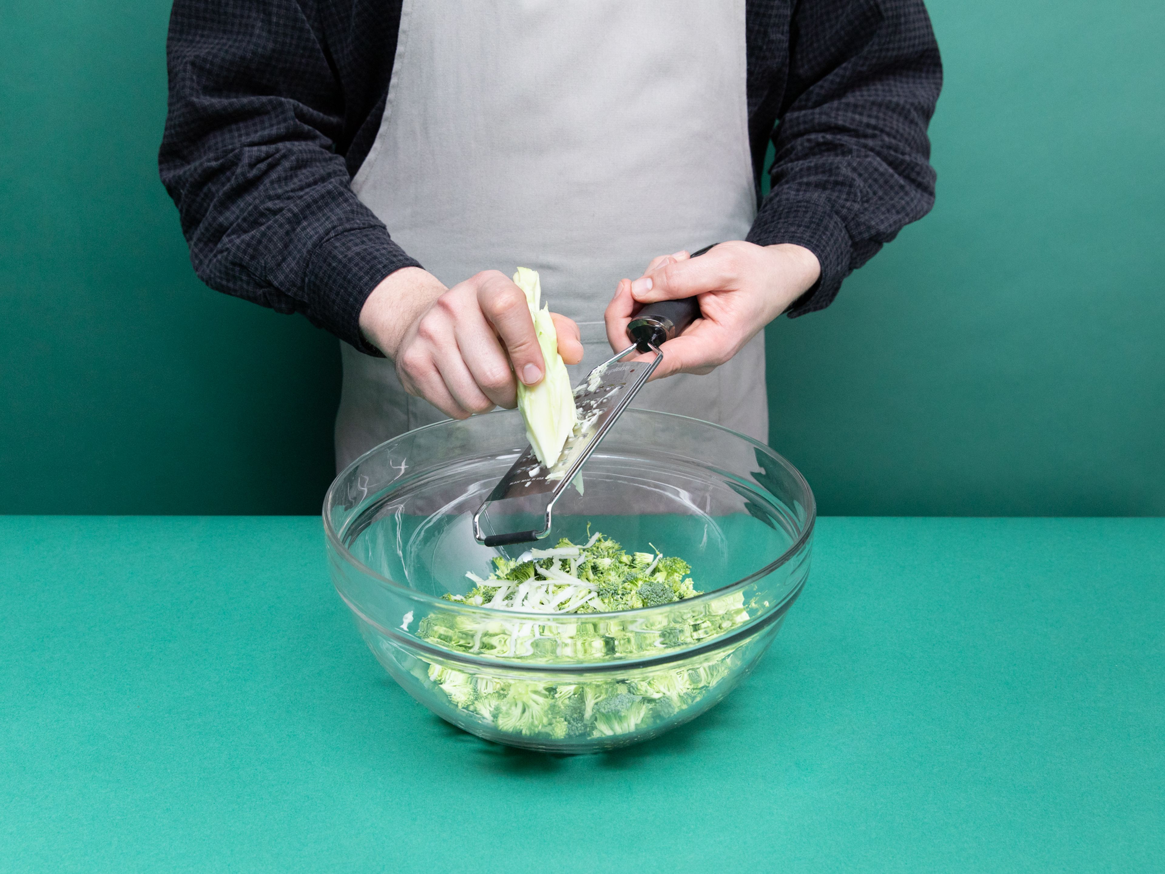 Preheat the oven to 160°C/325°F. Cut broccoli into very small florets and add to a large bowl. Peel the stem and use a grater to shave the stem into the same bowl with the florets. Do the same thing with the carrots. Peel and mince ginger. Thinly slice scallions at an angle.