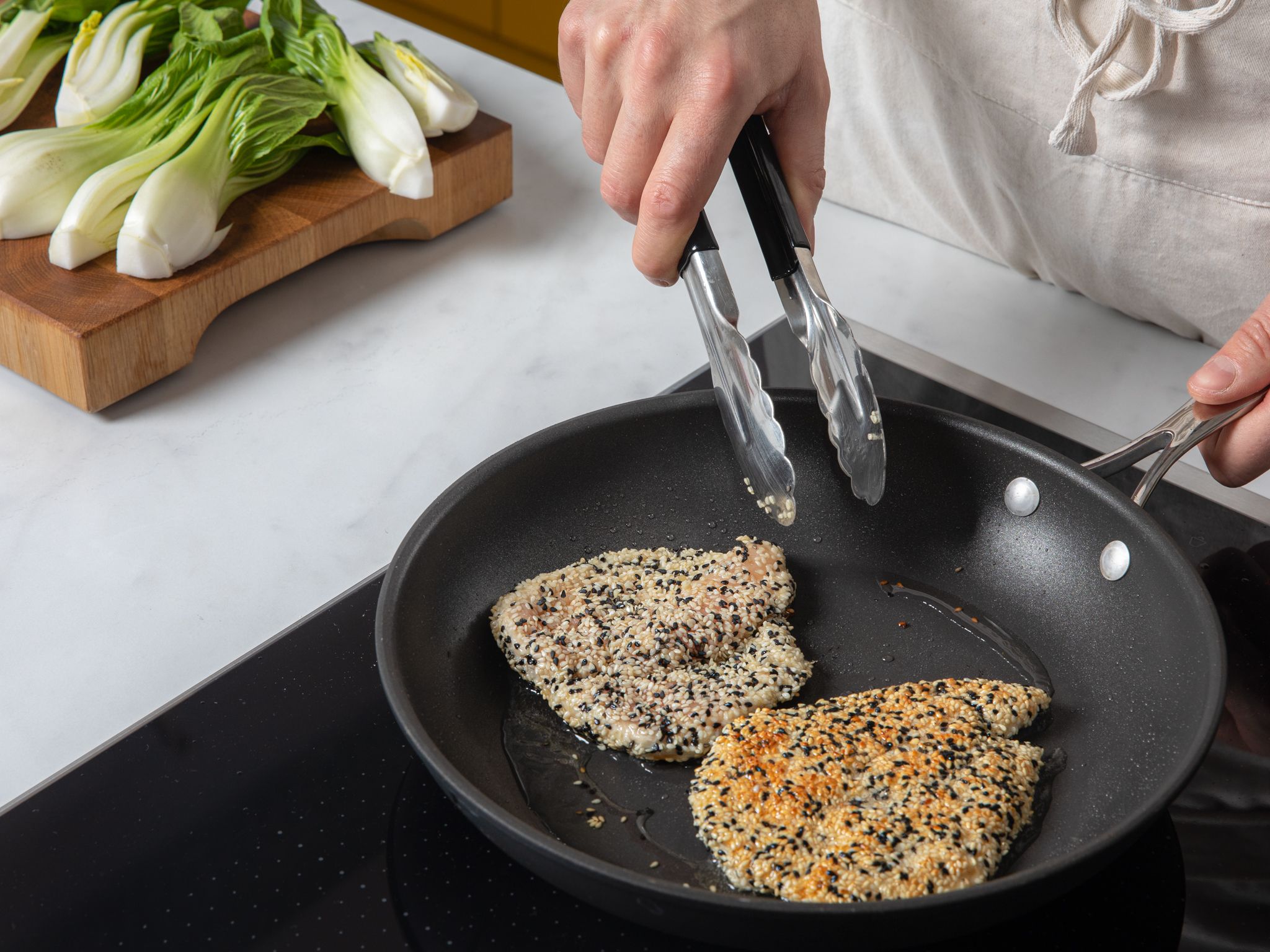 Crispy sesame chicken schnitzel with bok choy and peanut sauce Recipe