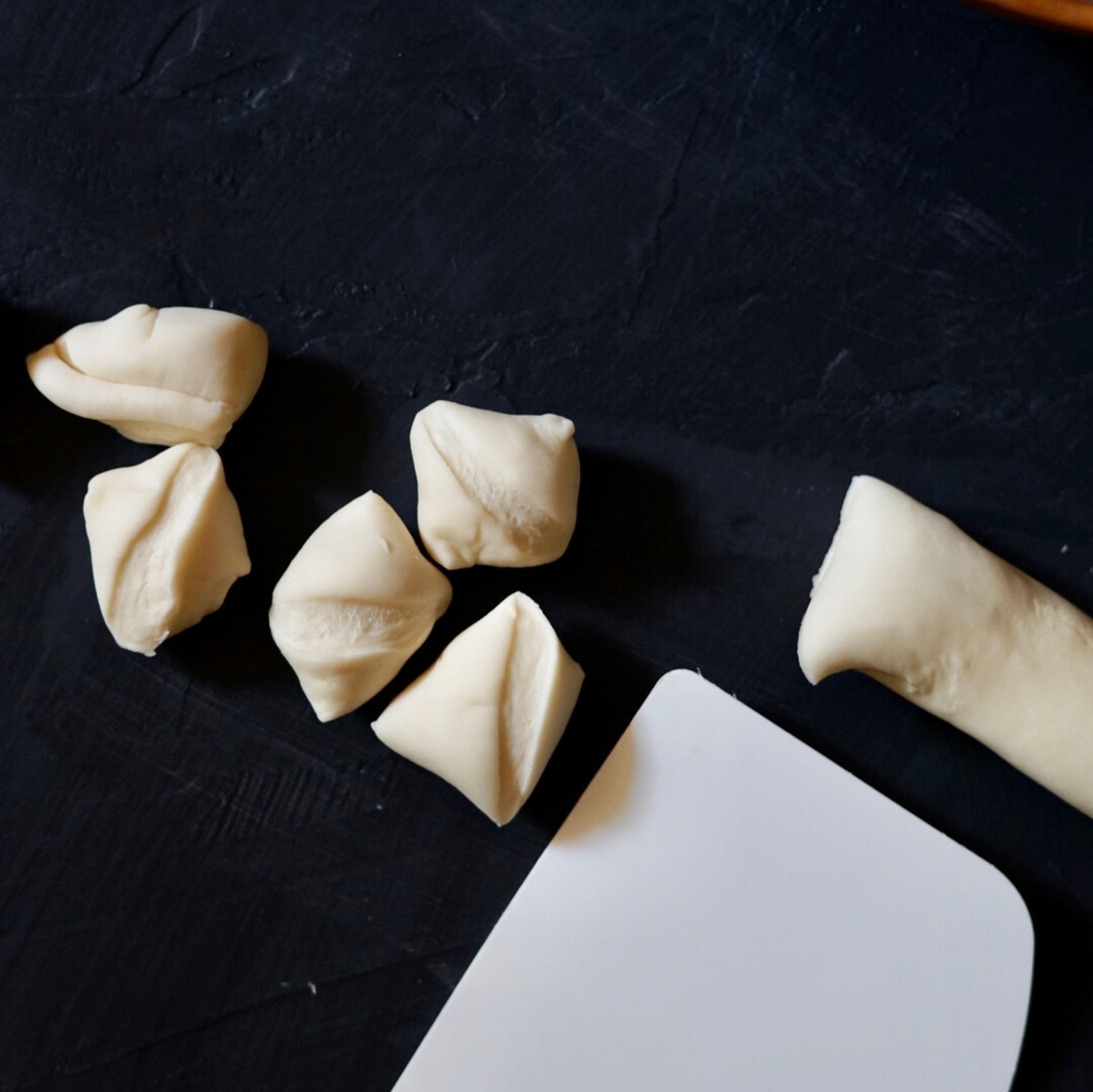 After 1 hour of resting, take out the dough and cut into small, even pieces. It should make around 50 dumplings wrappers.