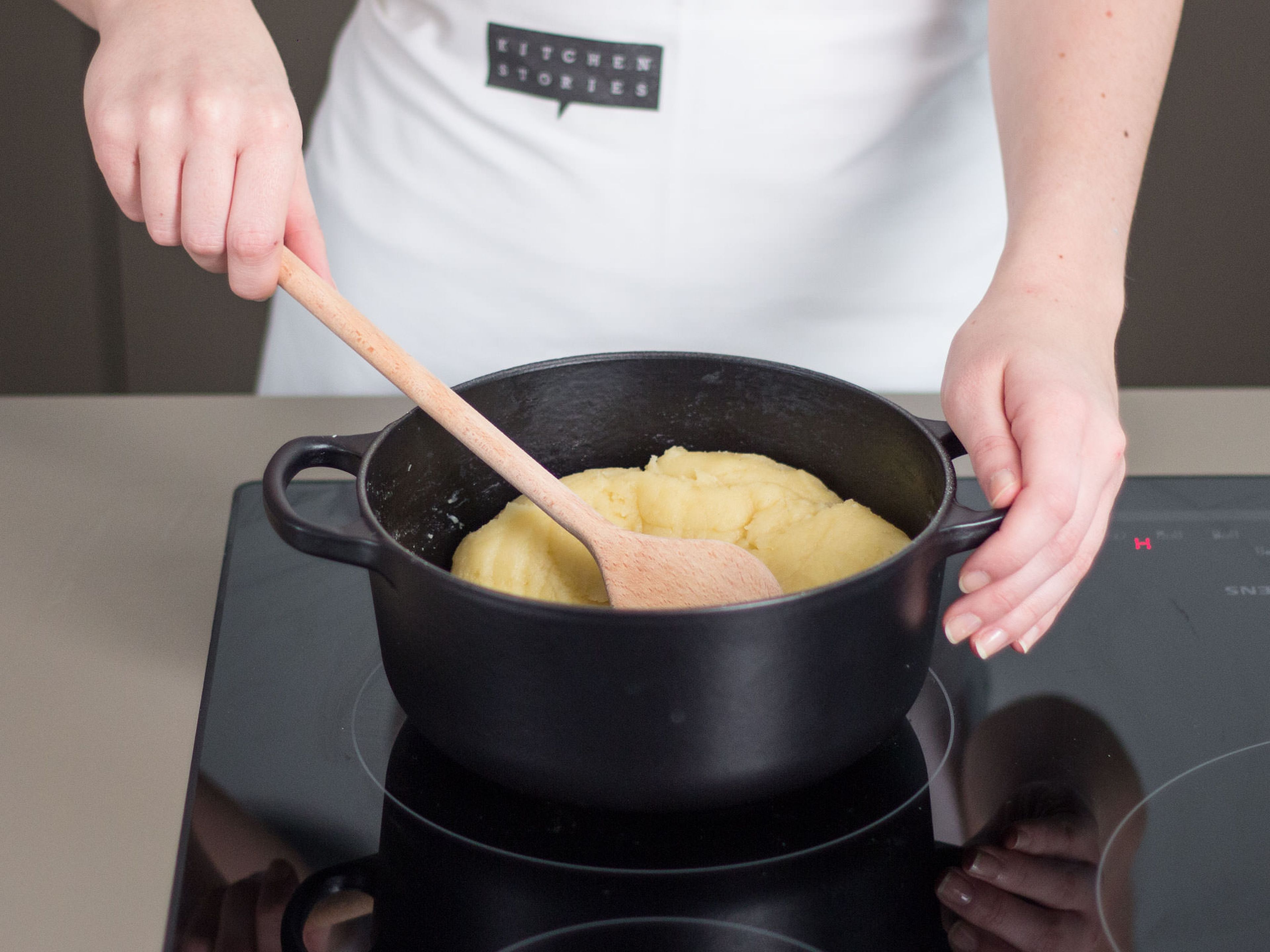 In a large saucepan, bring water, sugar, butter and salt to a boil. Then add flour, reduce heat to medium, and cook while stirring constantly until dough is golden in color. Now, transfer dough to a stand mixer and allow to cool for approx. 5 – 10 min.