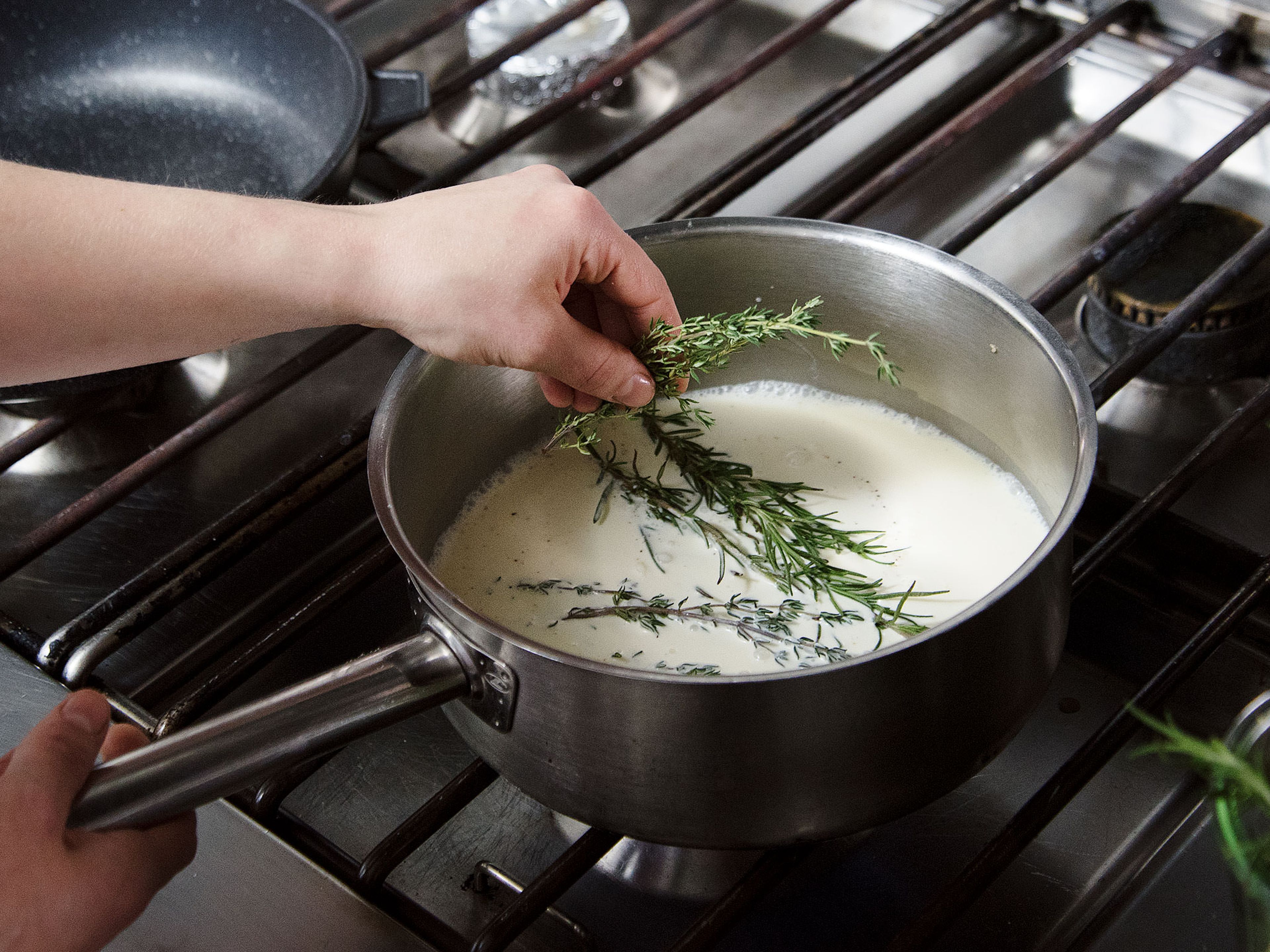 Preheat oven to 90°C/195°F. Separate egg yolks from egg whites, then beat egg yolks. Transfer cream and milk to a saucepan and add thyme, rosemary, and some sugar, salt, and pepper. Bring to a boil, then strain the mixture into a large mixing bowl. Mix in goat cheese and stir until melted.
