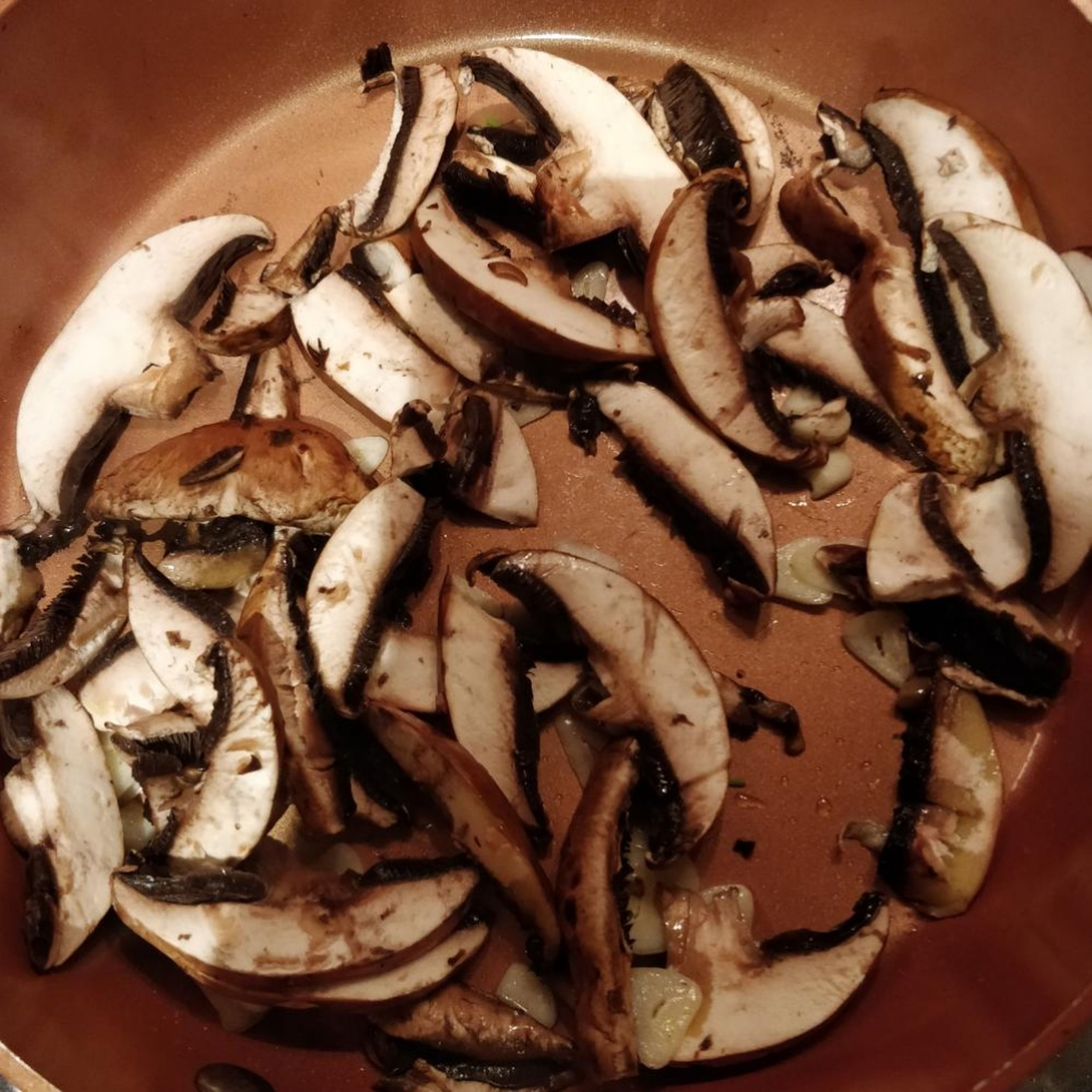 Heat a frying pan and add a knob of butter. when just melted, add the garlic and mushrooms and fry until soft and browned (approximately 5 minutes).