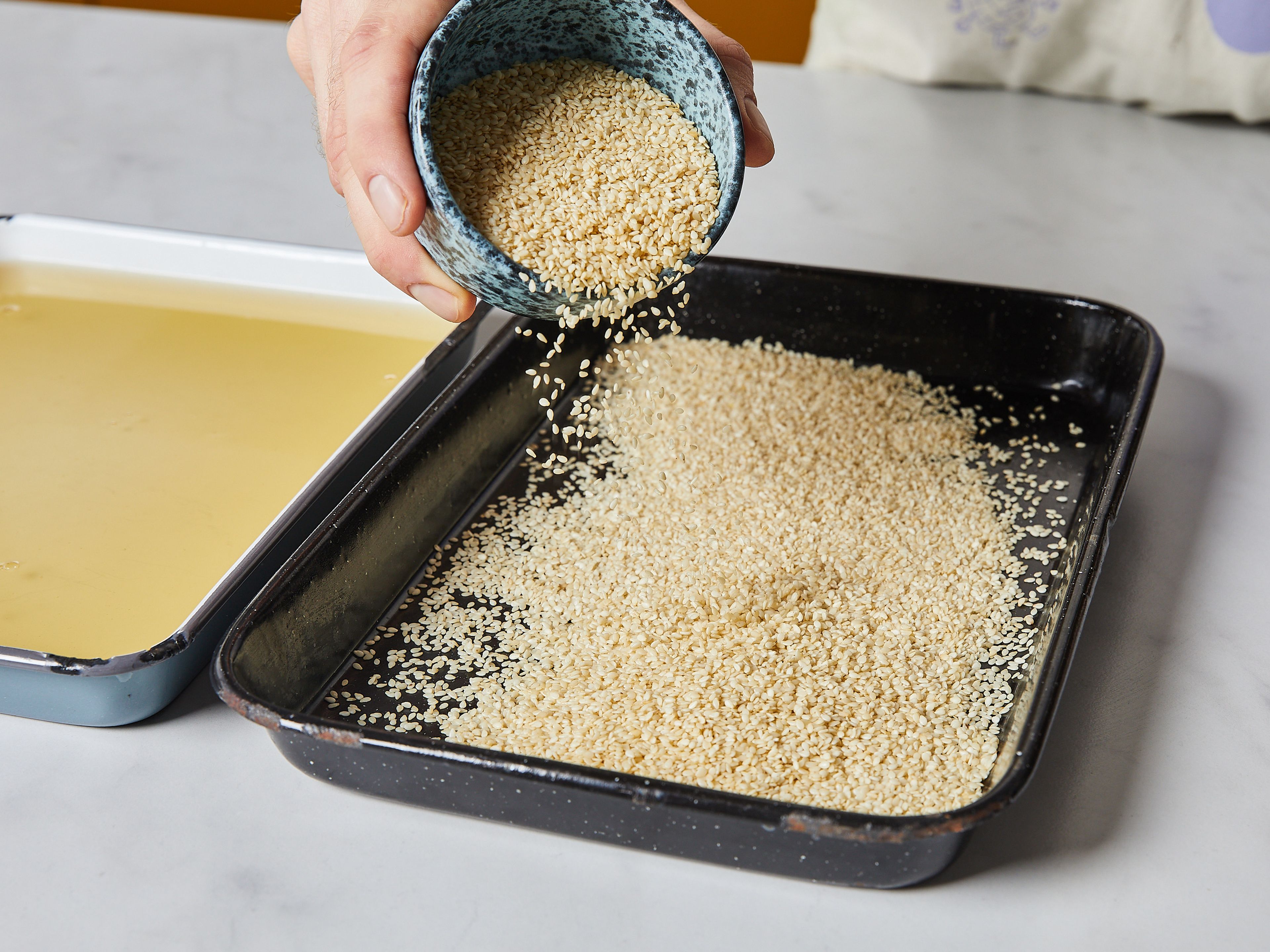 For the water bath: Add the rest of the water and honey to a shallow baking dish. Mix until dissolved. Add sesame seeds to a separate baking dish.