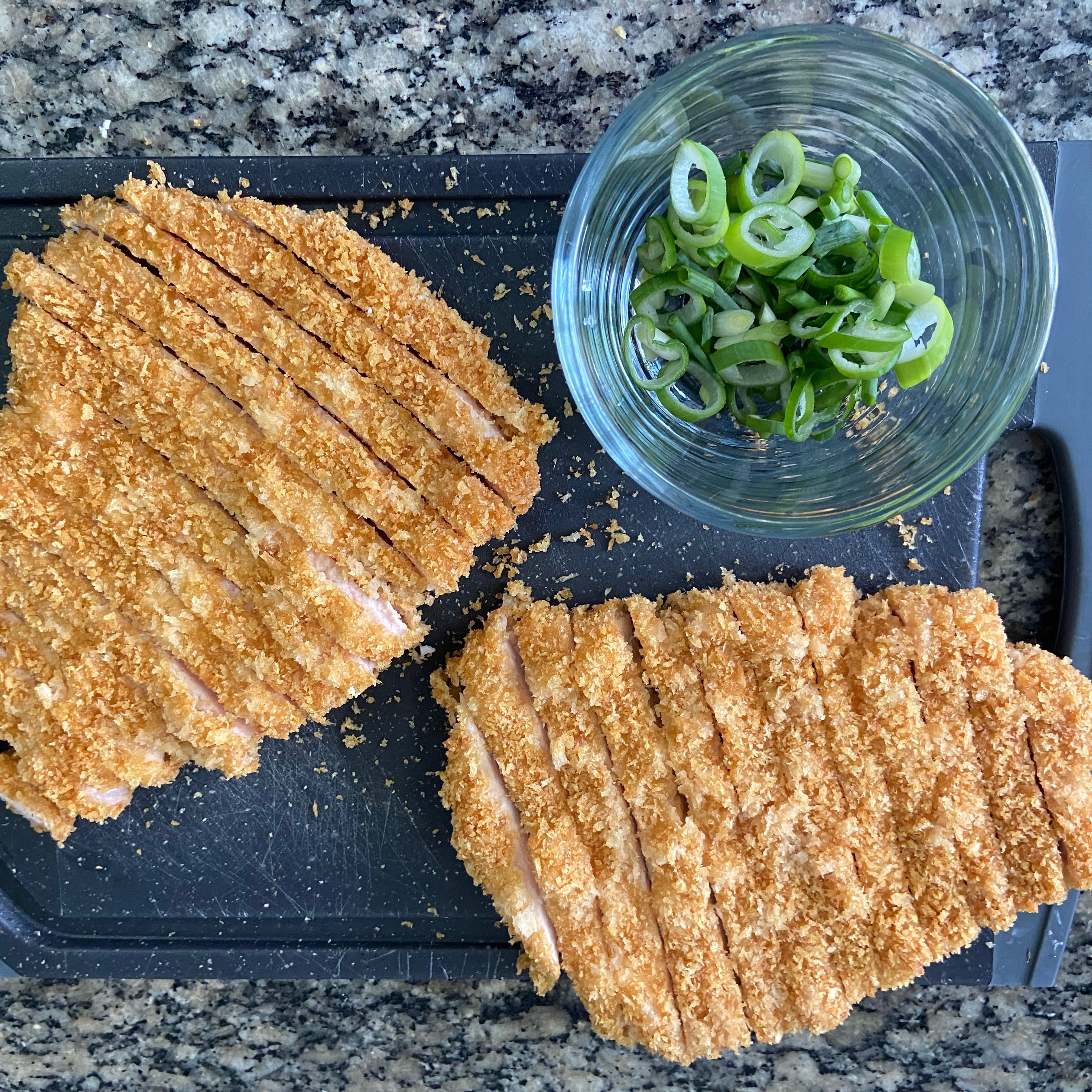 While the sauce is cooking, thinly slice two cutlets while still maintaining the original shape of the cutlet. Also, slice the scallion and set aside for garnishing at the end.