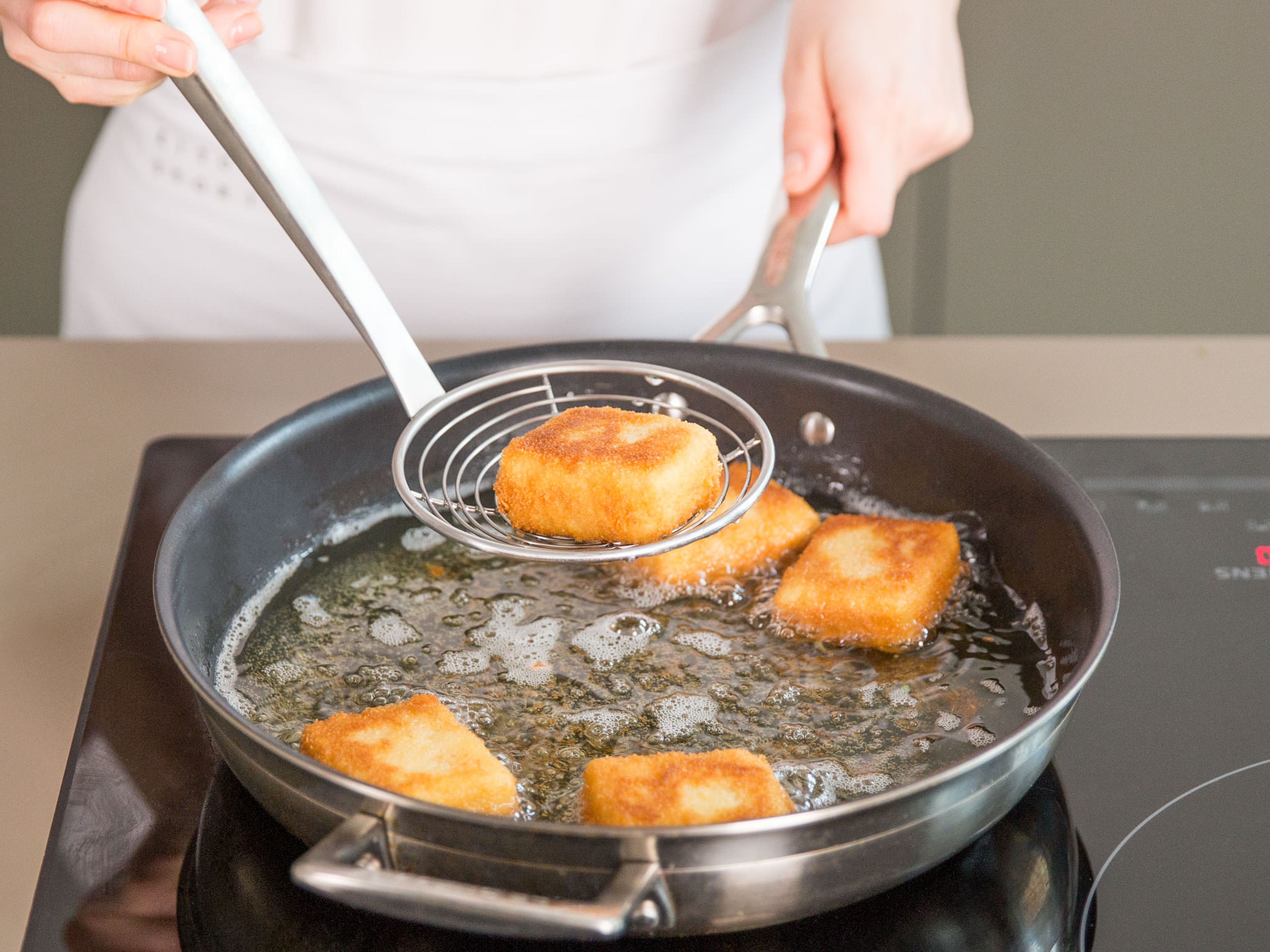 Heat oil in a large frying pan on medium heat. Sauté breaded squares from all sides for approx. 2 min. until golden brown. Transfer to a paper towel-lined plate to drain slightly.