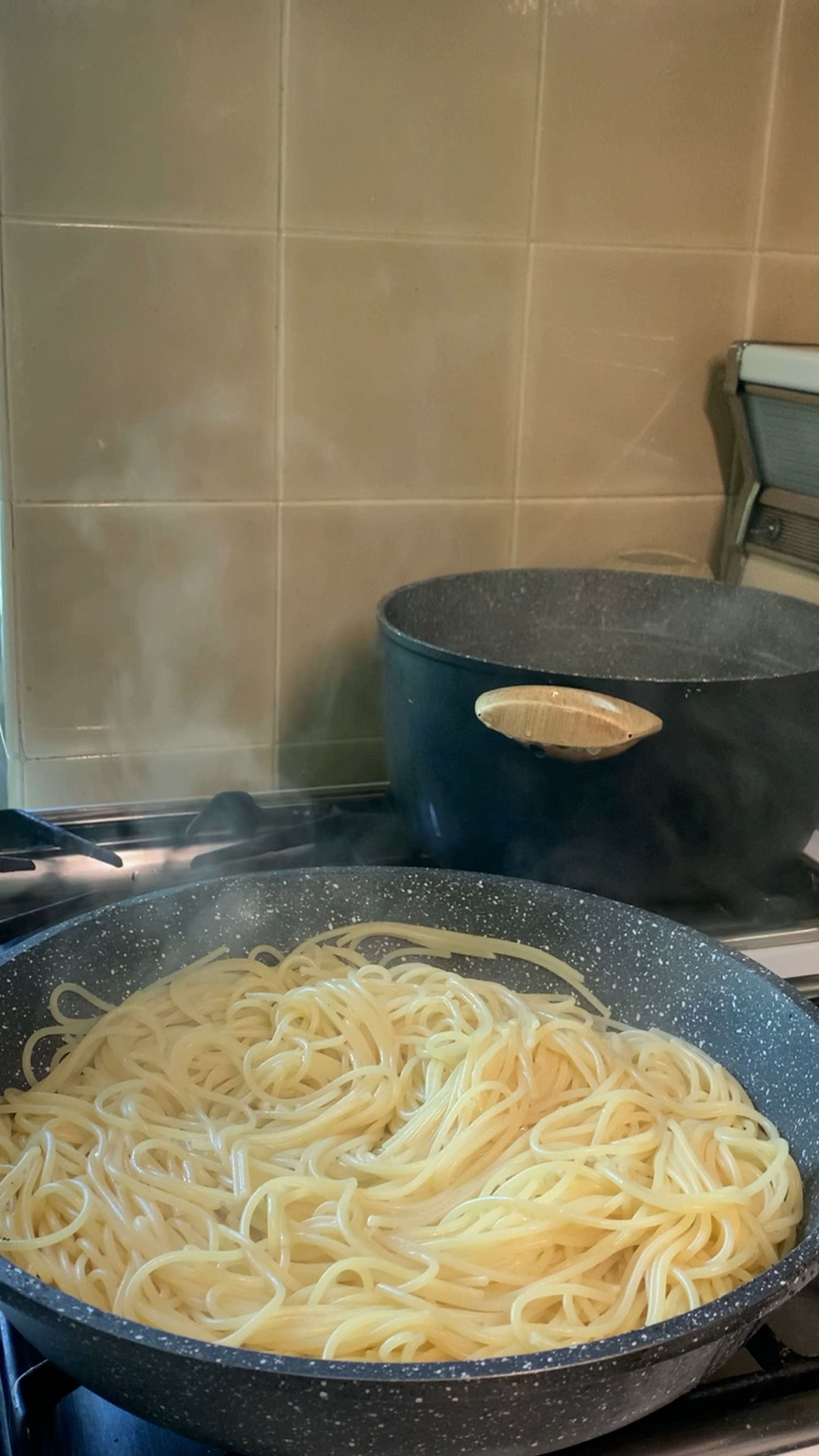 Add two tbsp of the remaining fat from pancetta to pasta and mix.