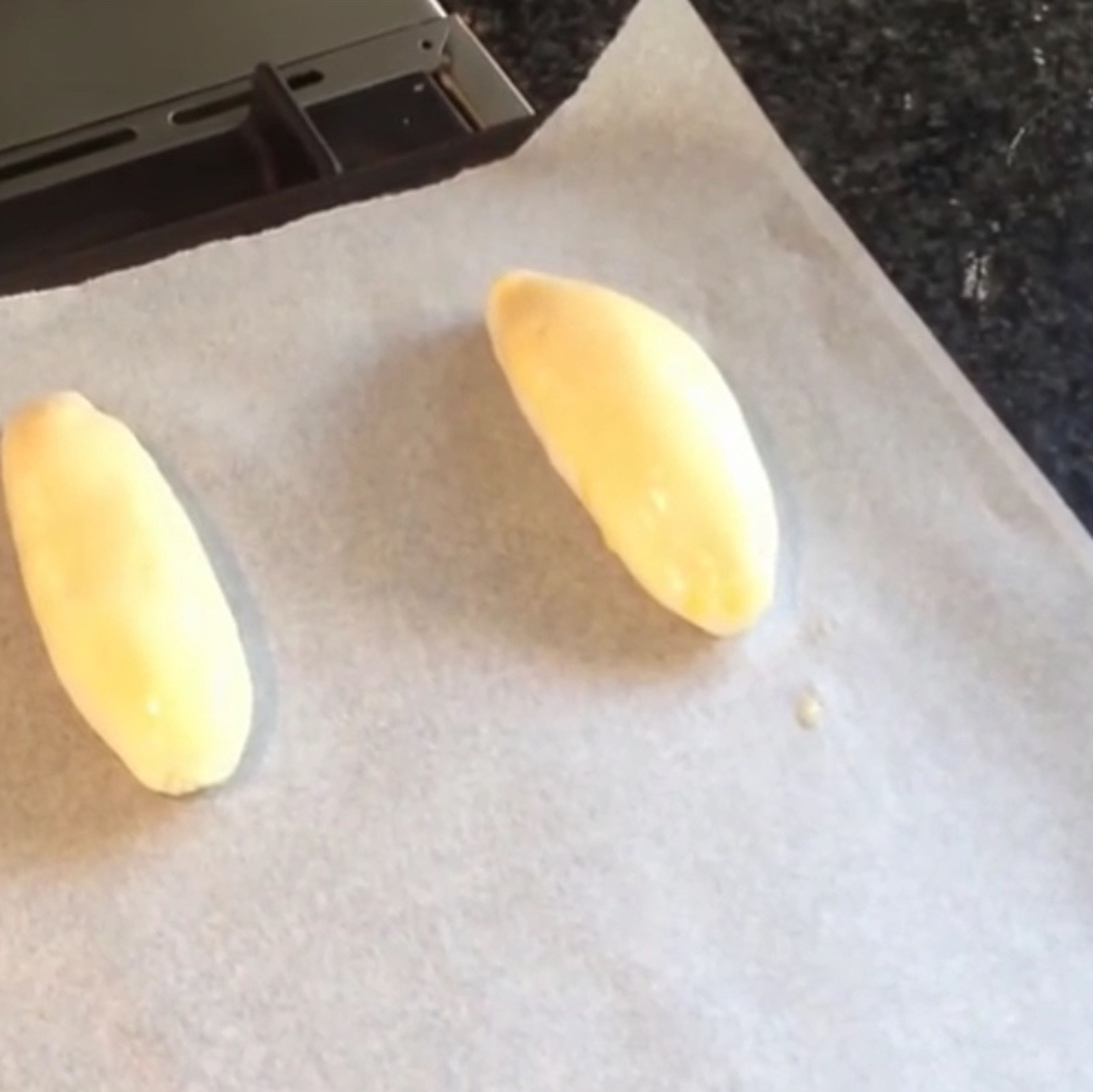 Softly roll the dough balls again then roll them into a longer shape. Place them on an oven tray on some baking paper. (Leave room for them to grow slightly)