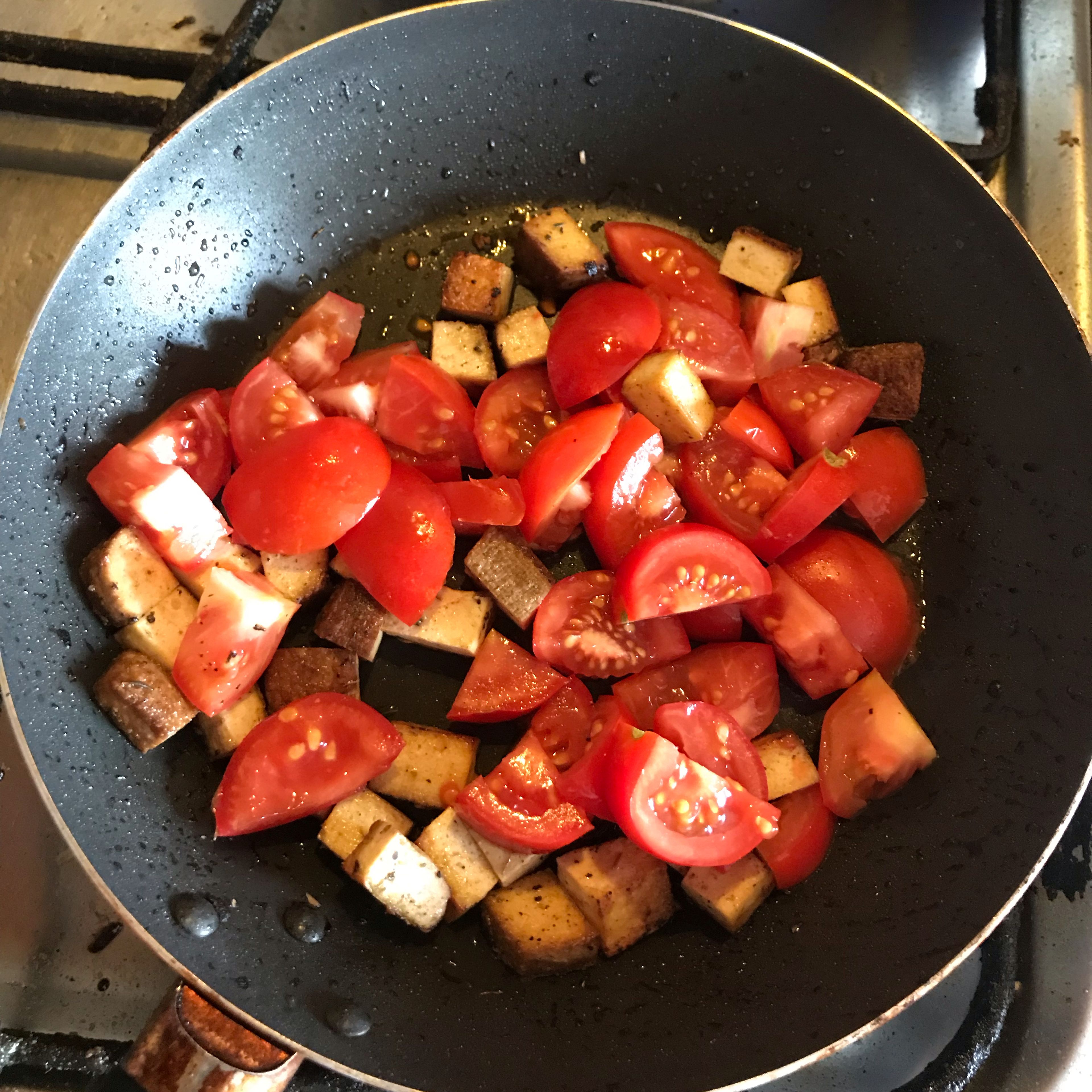 Chop tofu at cubes, add some herbs and fry a bit. Add choppef tomatoes and choppef spring onion and wait until tomatoes are soft.