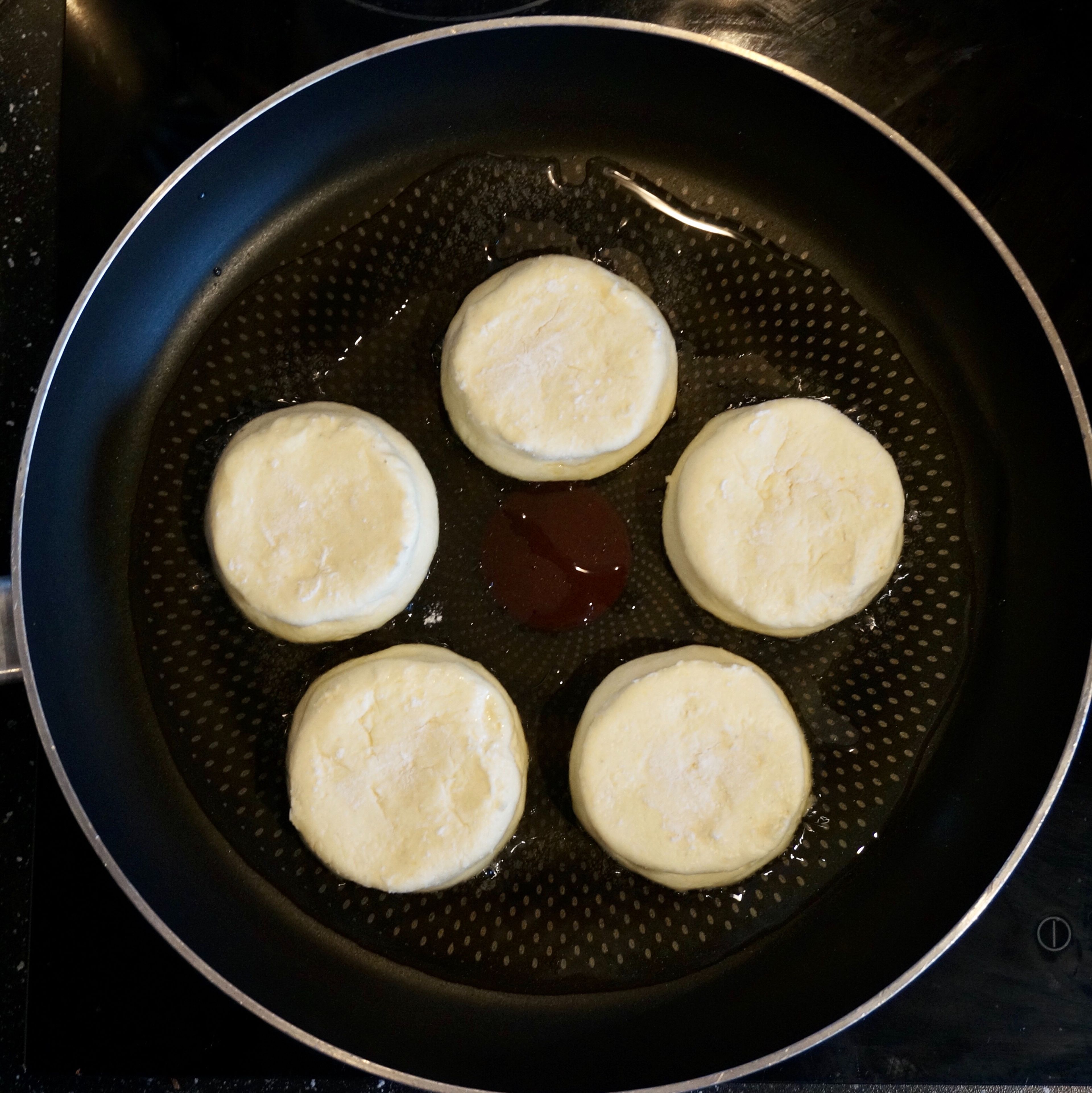 Add some oil to a preheated pan, put the “hockey pucks”. Fry them first on one side, then gently turn over and fry the other side, reduce heat and cover.