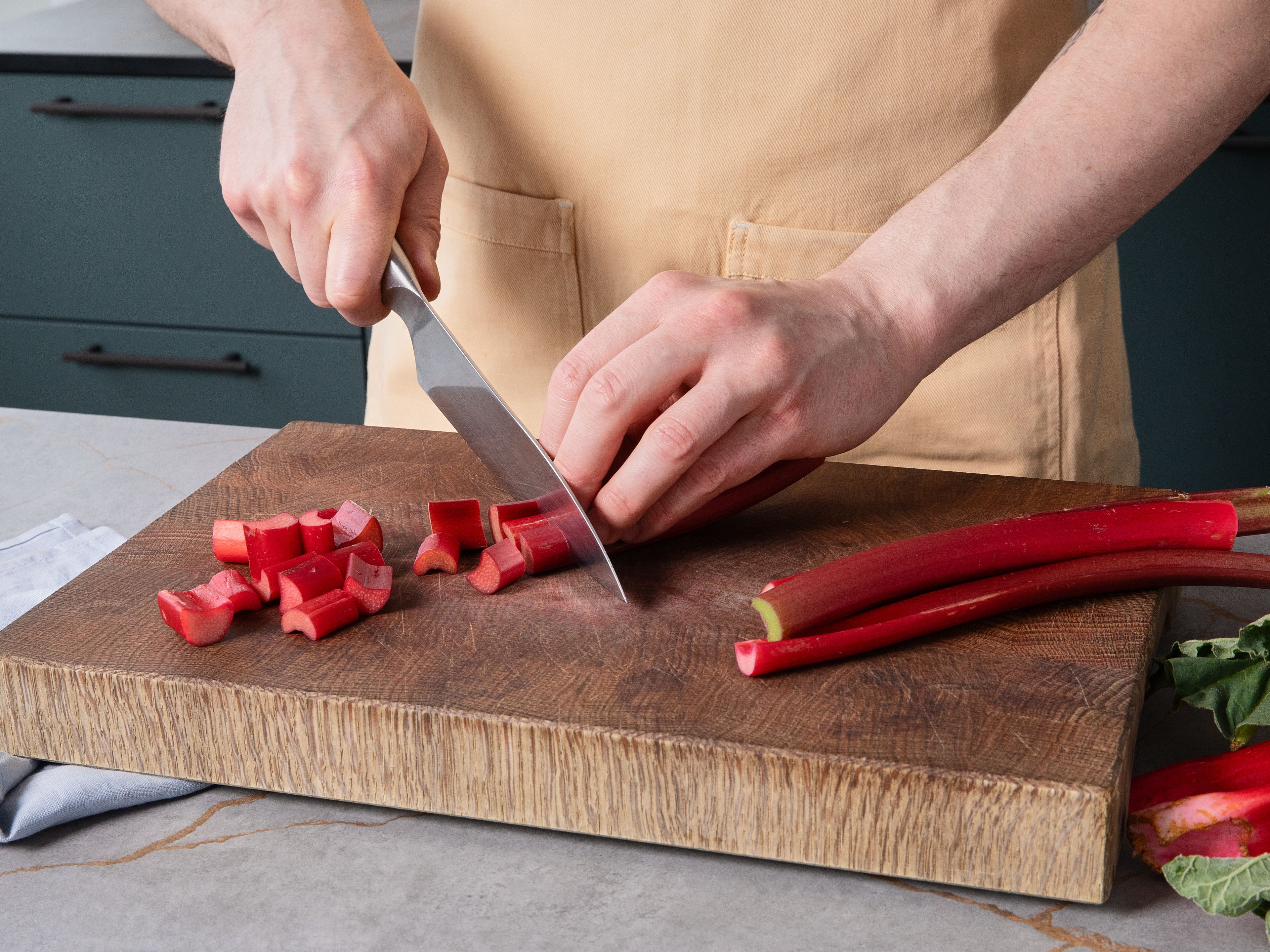 Preheat oven to 180°C/350°F (top/bottom heat) or 160°C/325°F (fan). Grease a baking dish with butter. Wash lemon with hot water, dry it, and zest the peel. Clean rhubarb, cut it into small pieces, and toss in a bowl with cornstarch.