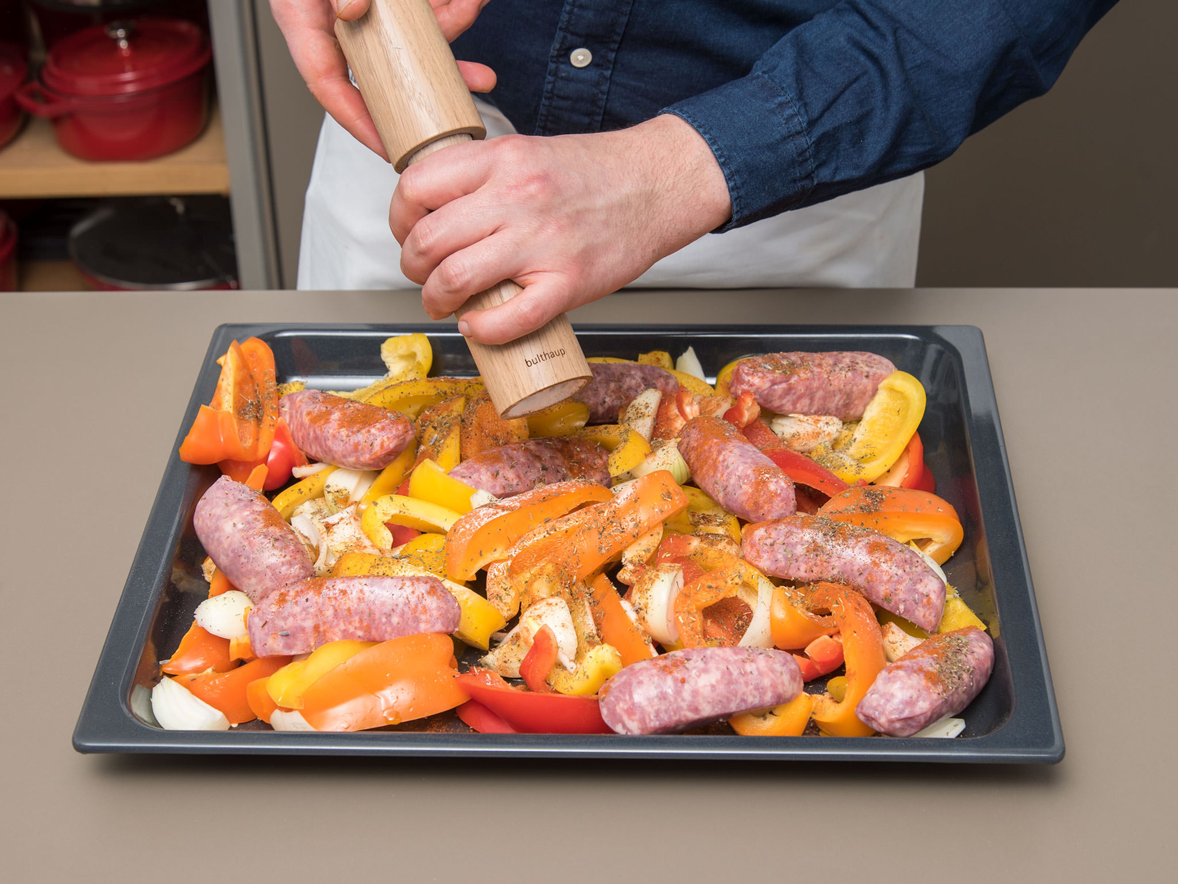 Spread onions and peppers out on a baking sheet and nestle in the sausages. Sprinkle with herbes de Provence, paprika, and oil and toss – making sure everything is coated evenly. Season with salt and pepper to taste.