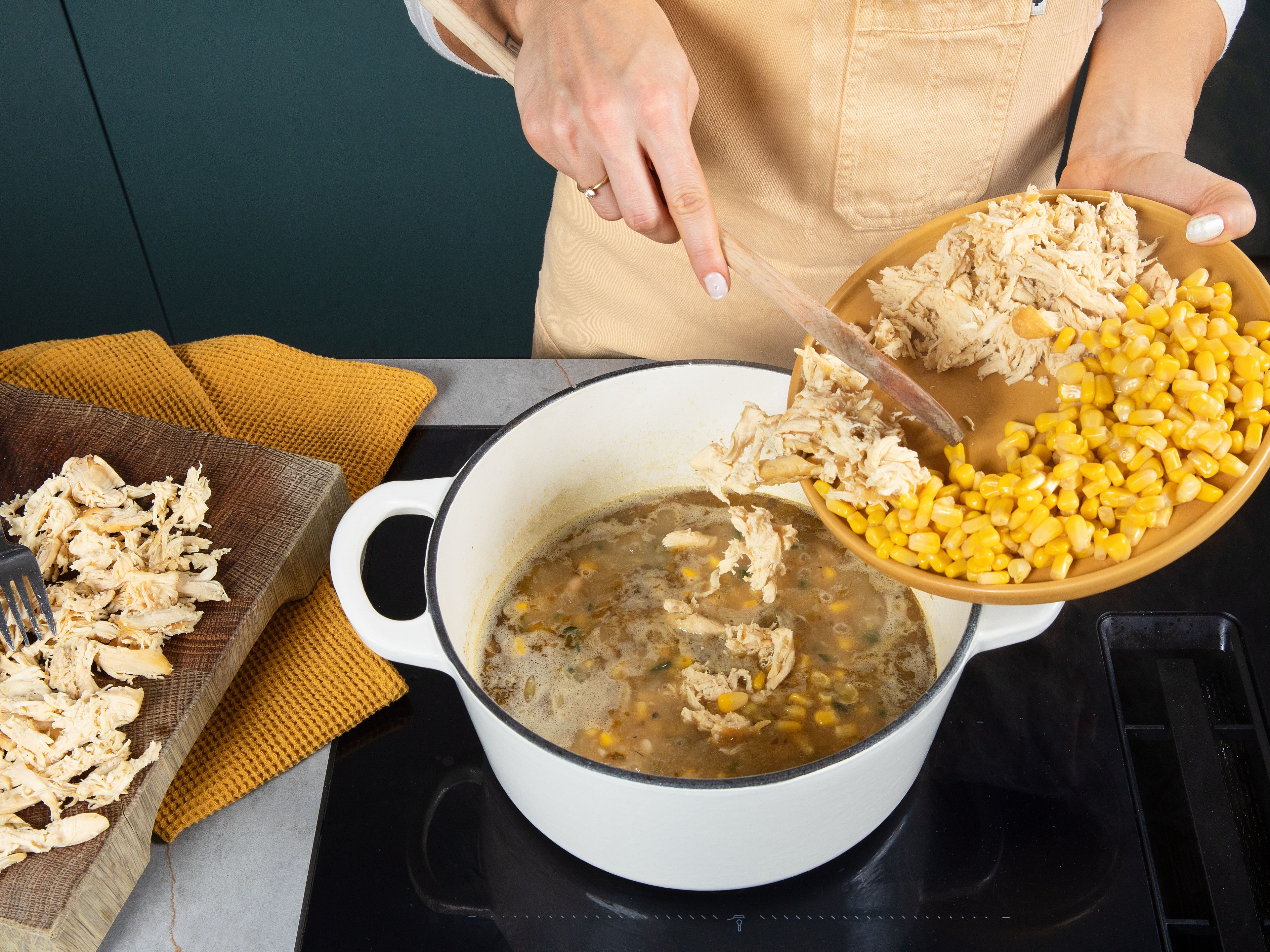 Remove the chicken from the pot and shred it into bite-sized pieces using two forks. Add the beans to the pot and let simmer for approx. 10 min. Add the shredded chicken along with the drained corn.