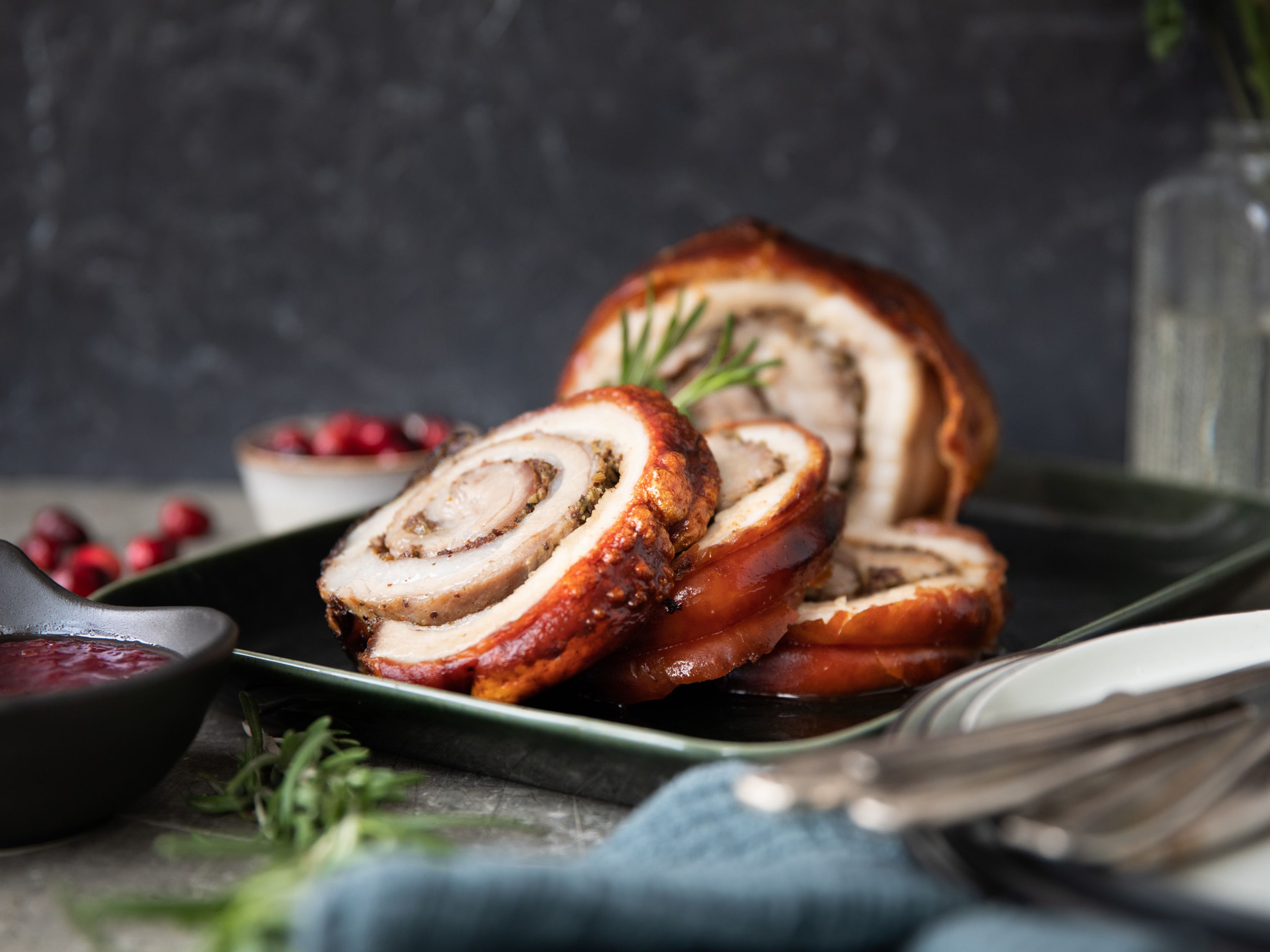 Crispy rolled pork belly with cranberries and herbs