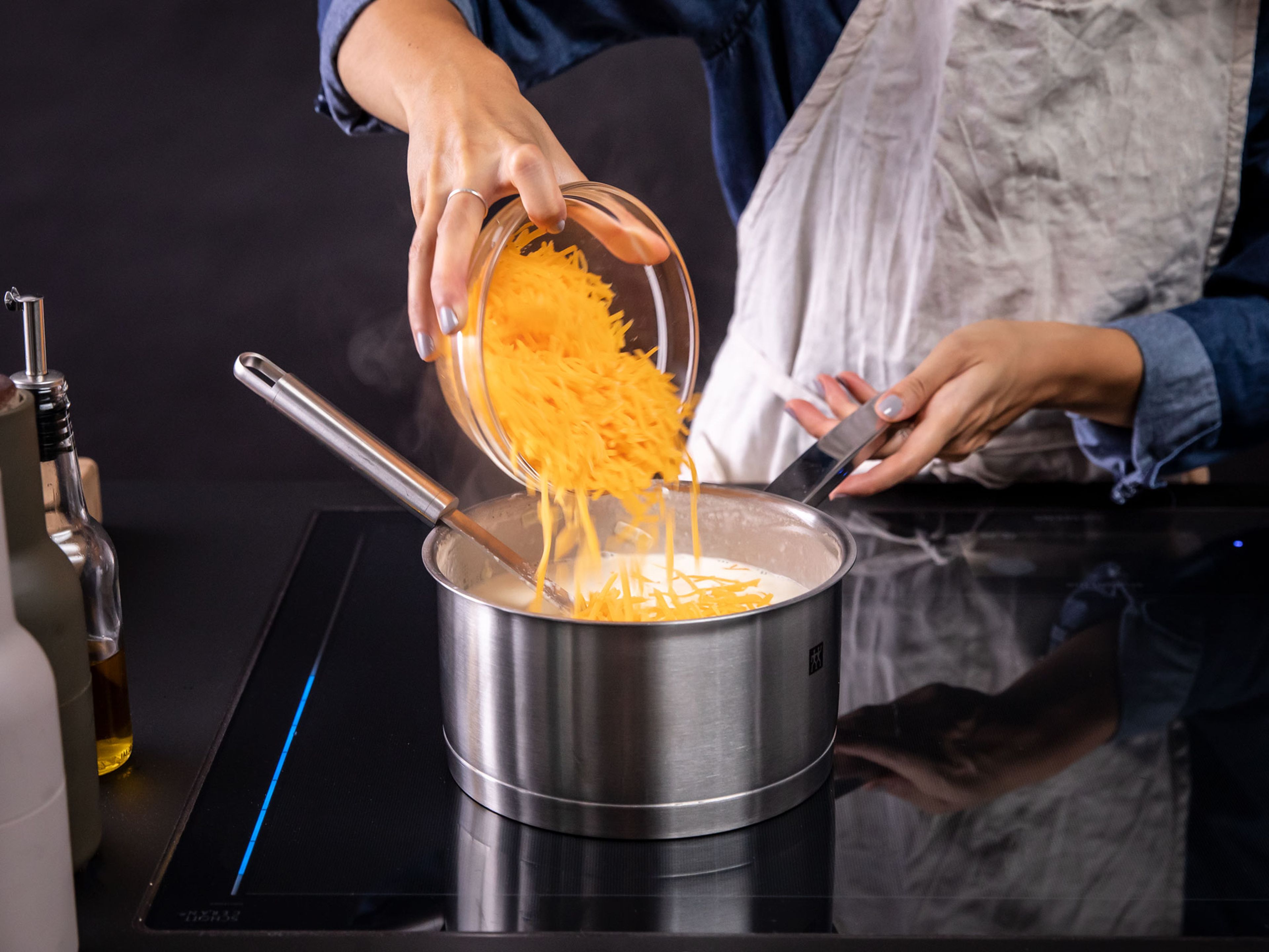 Stir in remaining butter and two-thirds of shredded cheddar cheese. Once cheese has melted and mixture is creamy, add ham and stir to combine.