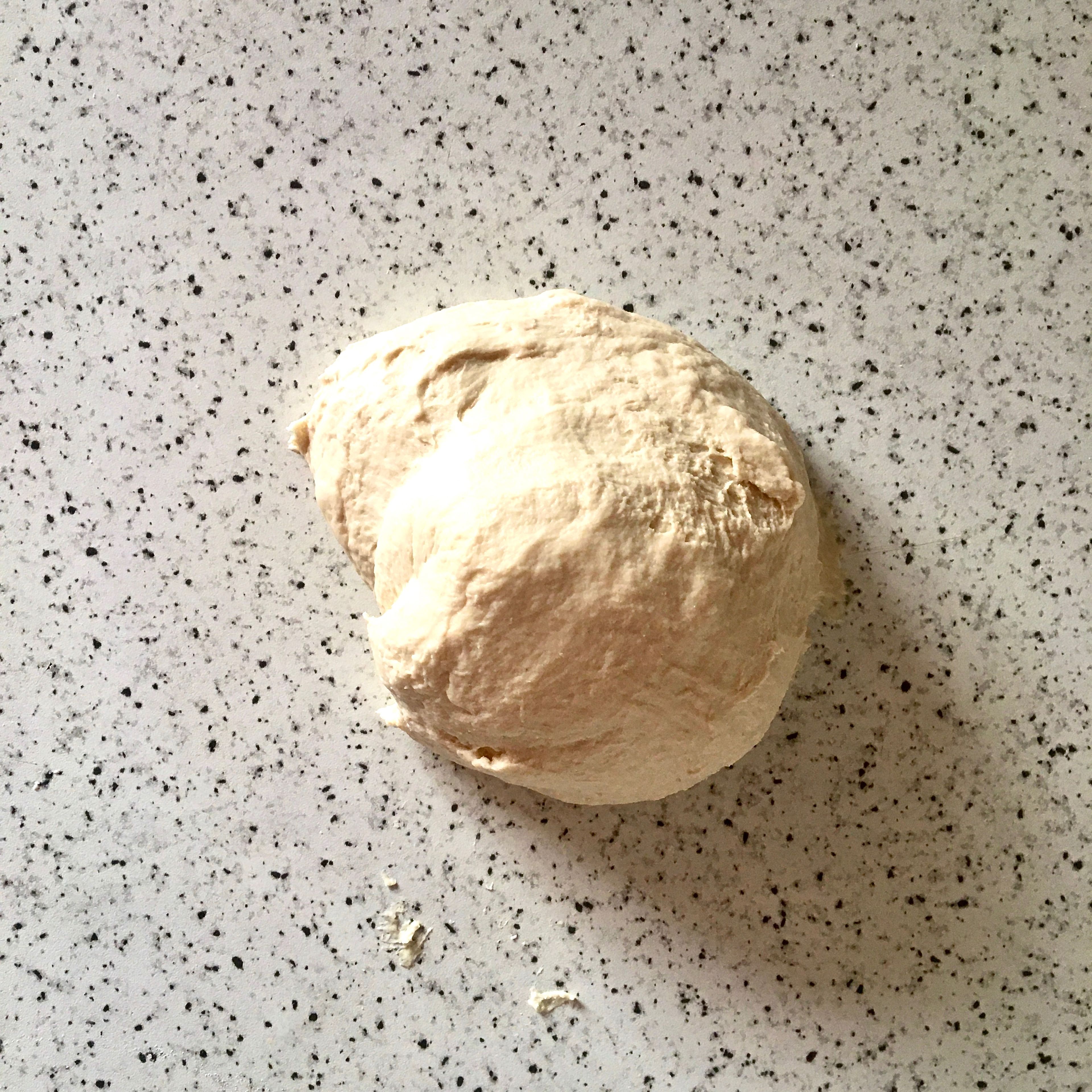 Transfer the dough onto a lightly floured surface and knead until smooth and elastic, about 8 min. If the dough seems too sticky, dust with just a little bit more flour.