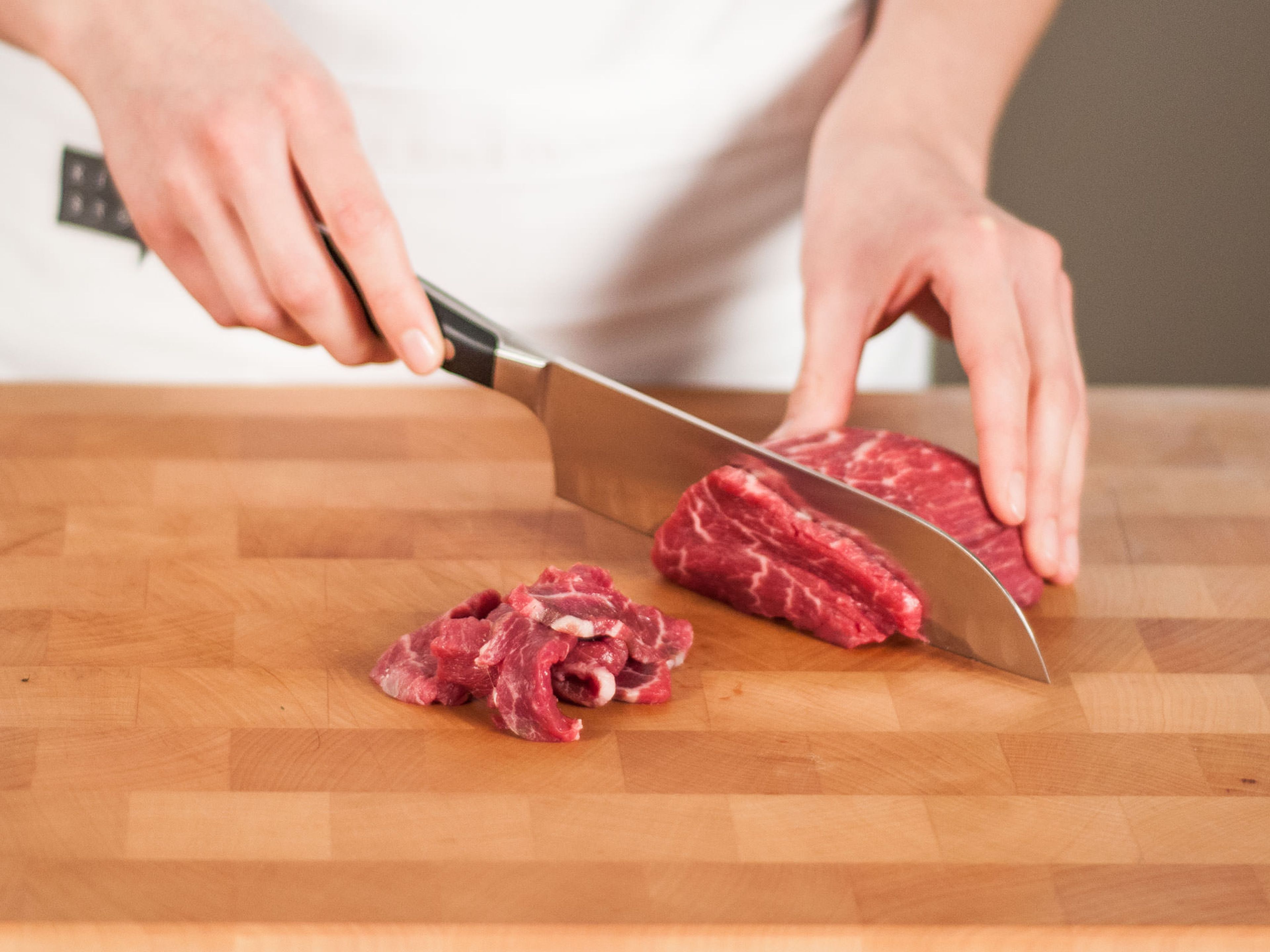 Cut beef into thin strips.