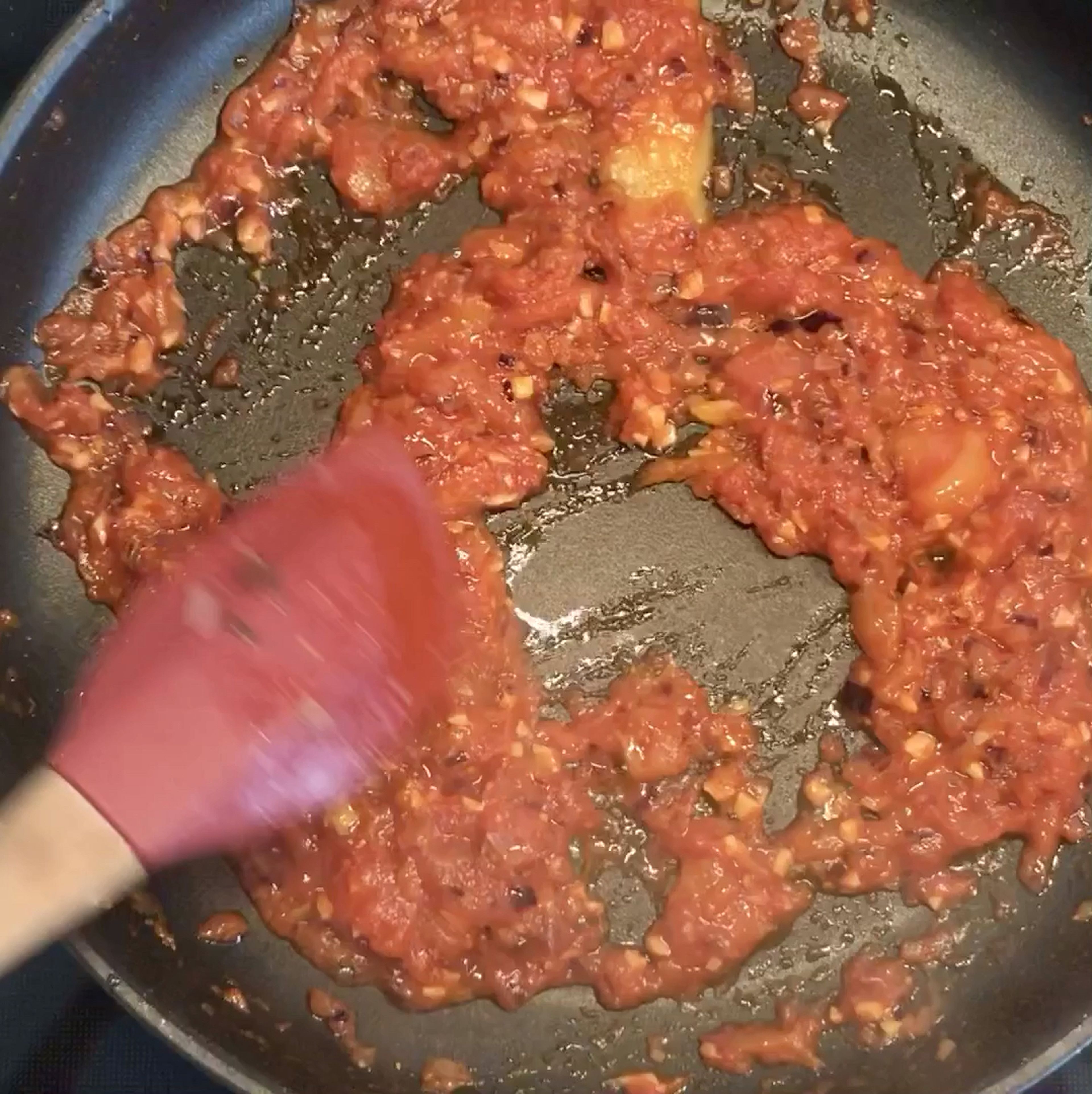 Add the drained whole tomatoes to the frying pan and break them up roughly using your spoon. Add chilli flakes, lemon zest, and tomato paste. Fry until most of the liquid has evaporated and the tomatoes are darker in colour, approx. 5 min. Add canned tomato liquid, stir through and let bubble, then bring the heat down to a gentle simmer.