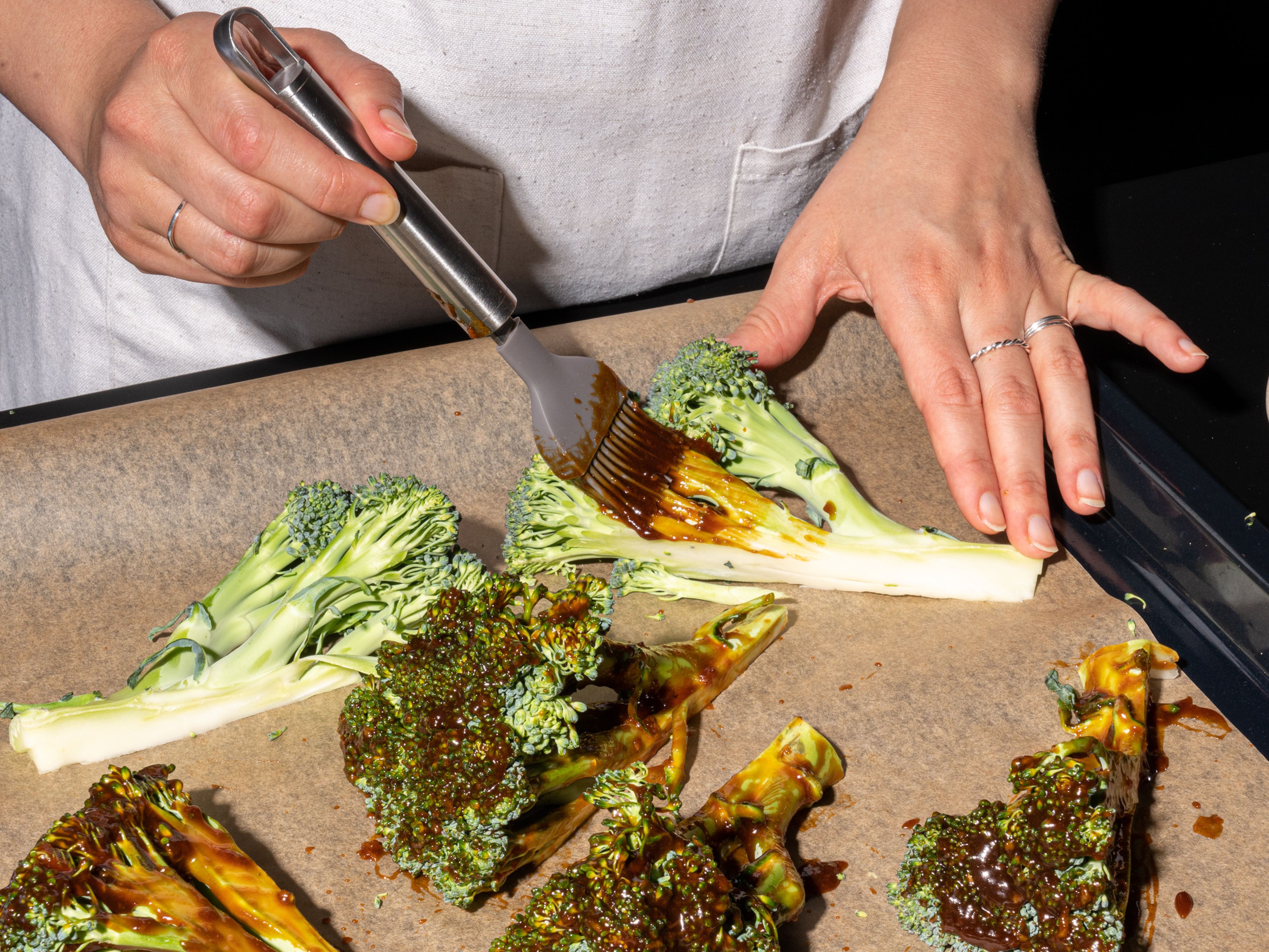 Transfer broccoli to a lined baking sheet. Brush with the hoisin glaze and drizzle with vegetable oil. Season with salt and roast for approx. 15 min. Flip and let roast for approx. 10 min. more, or until the broccoli is charred and fork tender in the thickest parts of the stem.