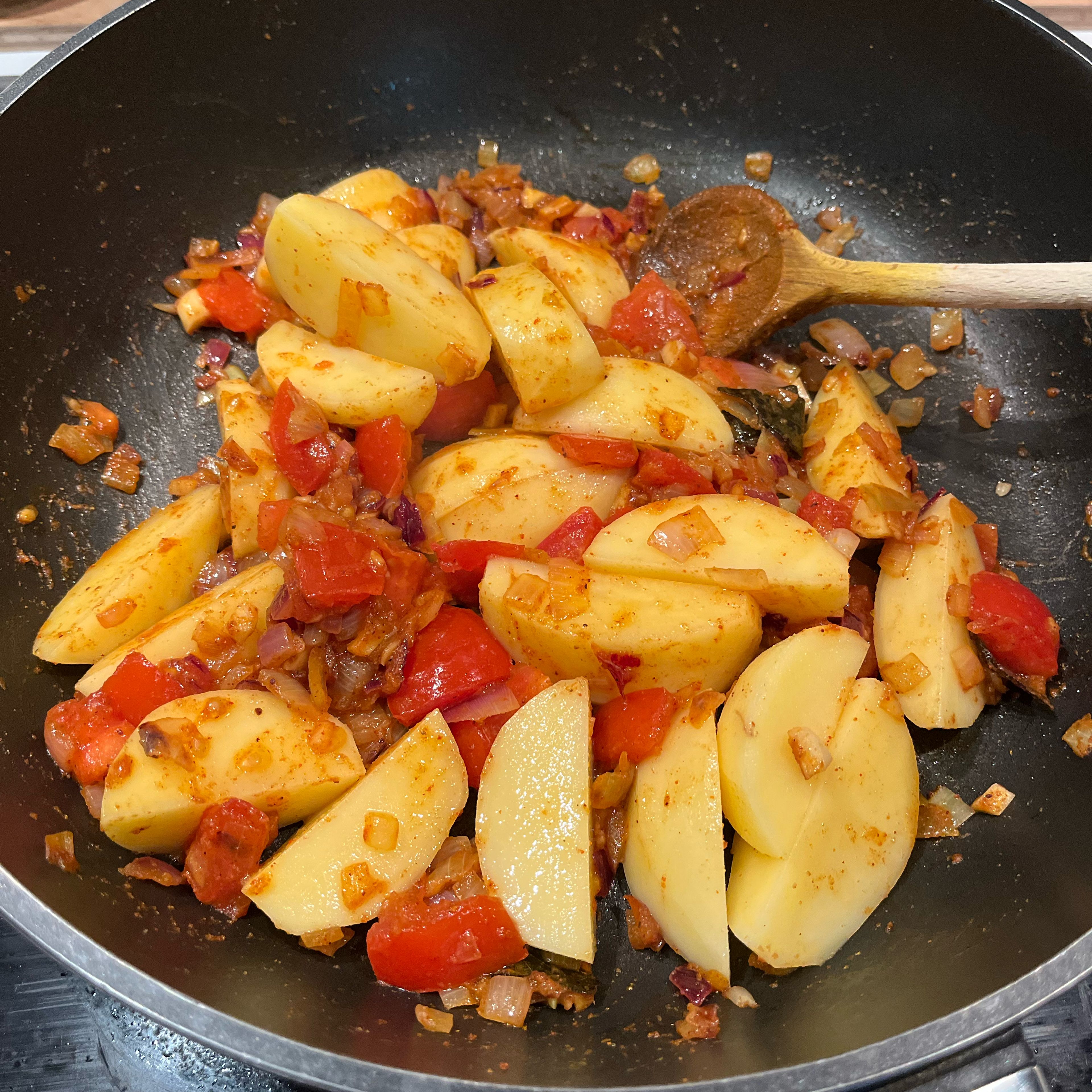Add potatoes and stir. Add 250ml of water, bring to boil, cover with a lid and simmer on medium heat till potatoes are done, about 15min.