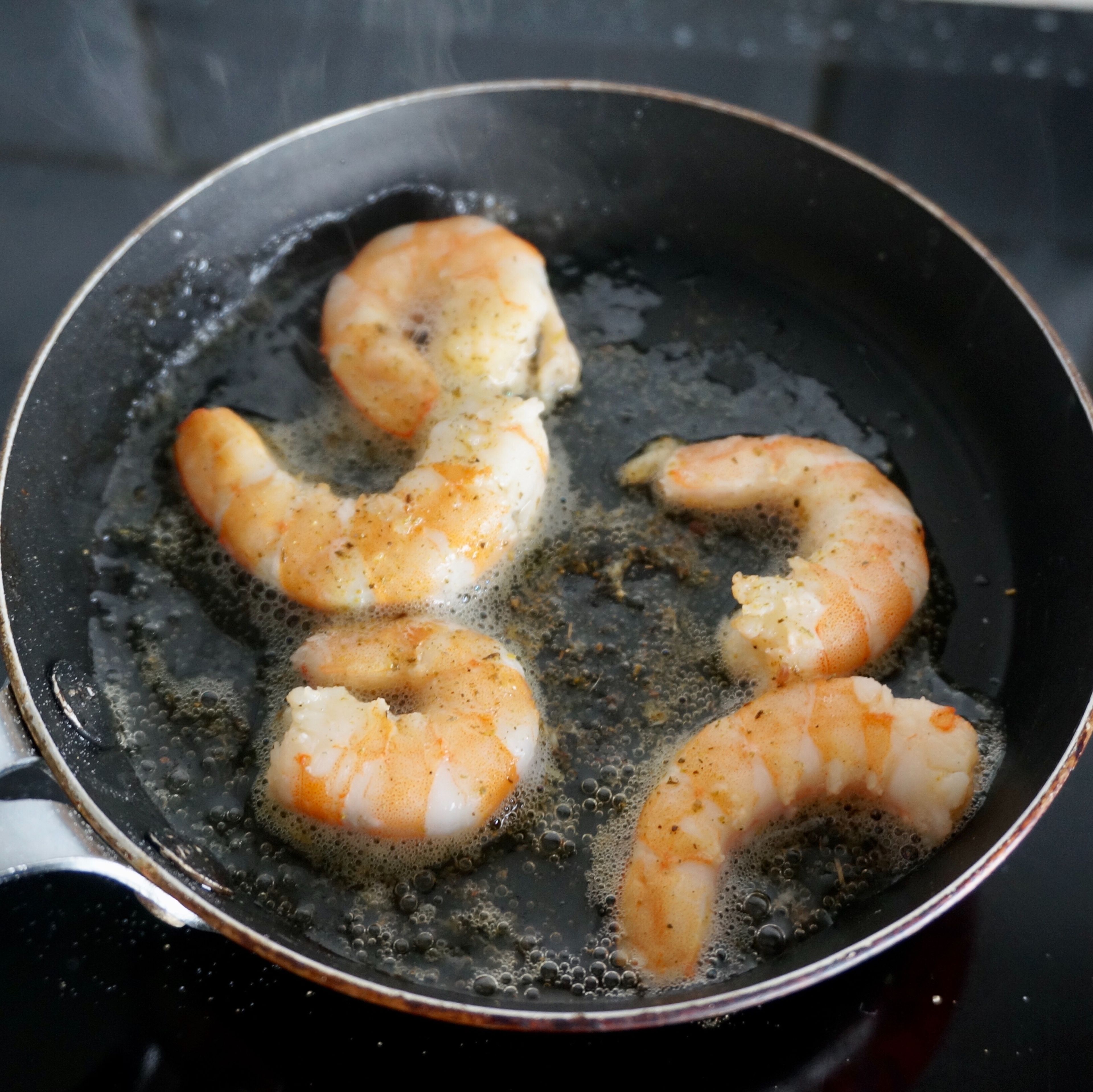 Peel the shrimps. Pour olive oil into a preheated pan, fry the shrimps on both sides, season with salt and sprinkle them with Provencal herbs. Fry for 2-3 minutes, until the shrimp are ready.