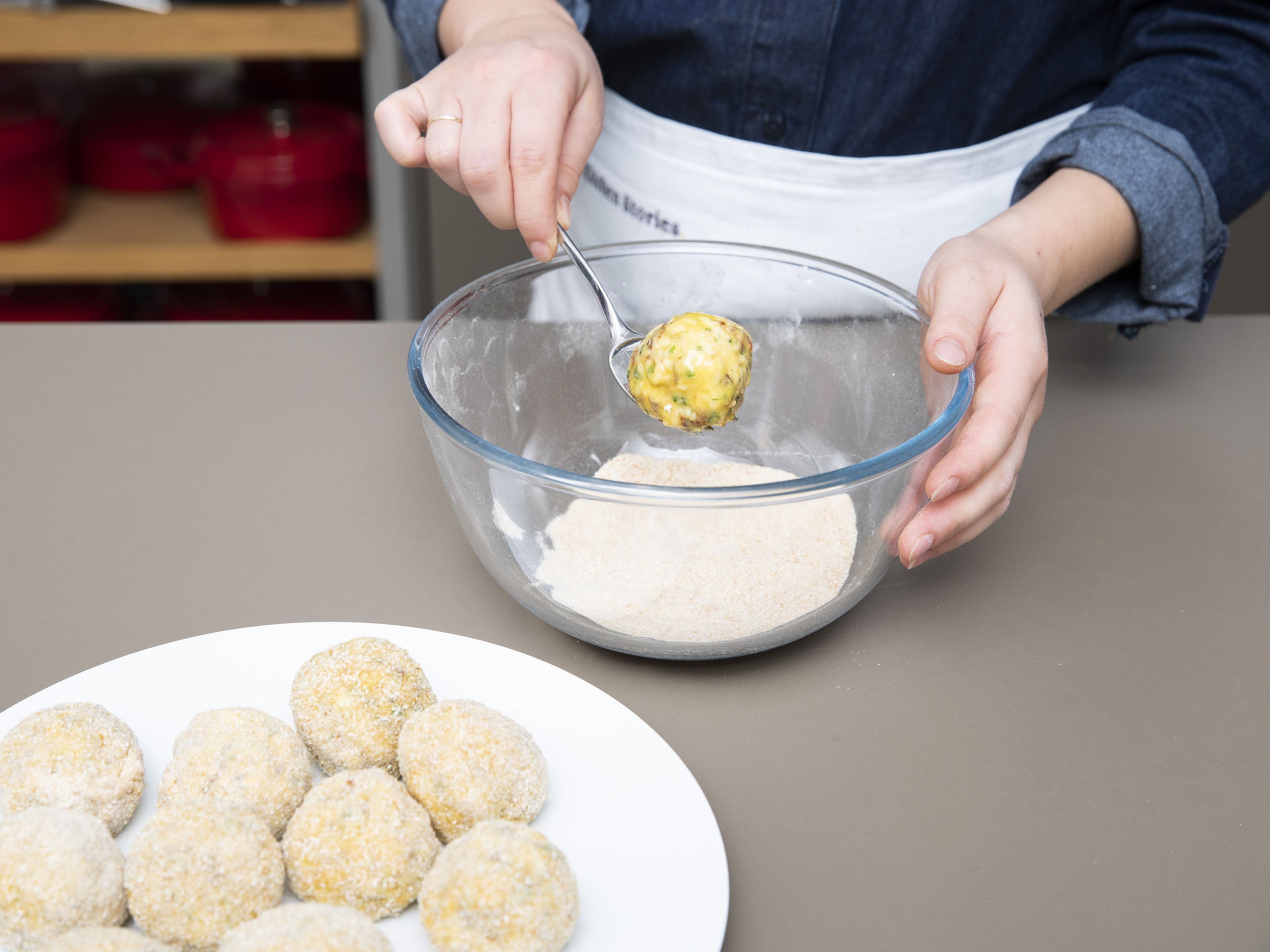 Prepare three shallow bowls for breading. One for the flour, one for the lightly beaten egg, and one for the breadcrumbs. Cover each arancini in flour, then beaten egg, and then breadcrumbs, using either your hands or a fork.