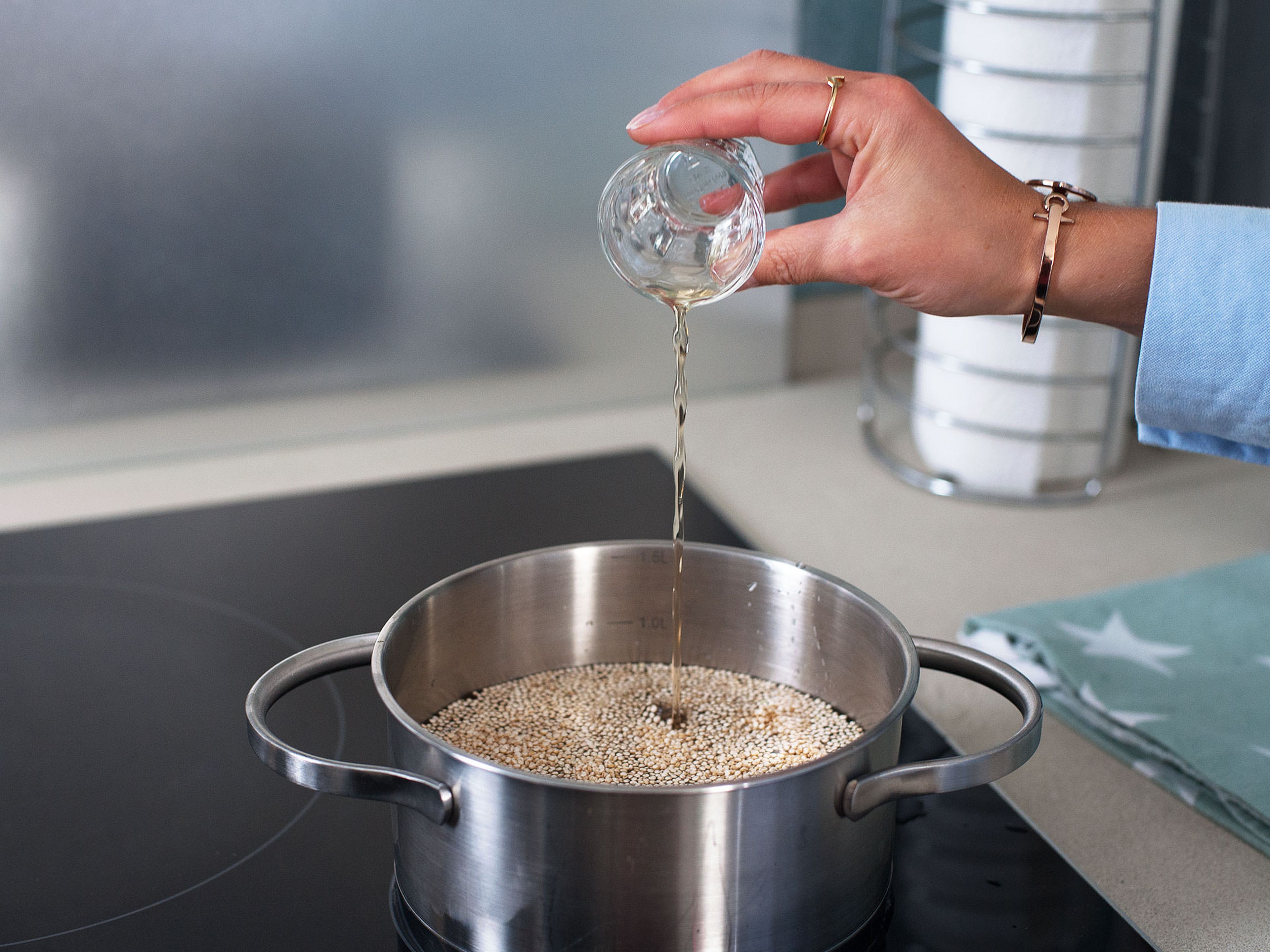 Meanwhile, prepare quinoa according to package instructions, boiling it with the cider vinegar and some of the lemon juice. When little white rings begin to form around the grains, drain any excess water and set quinoa aside.