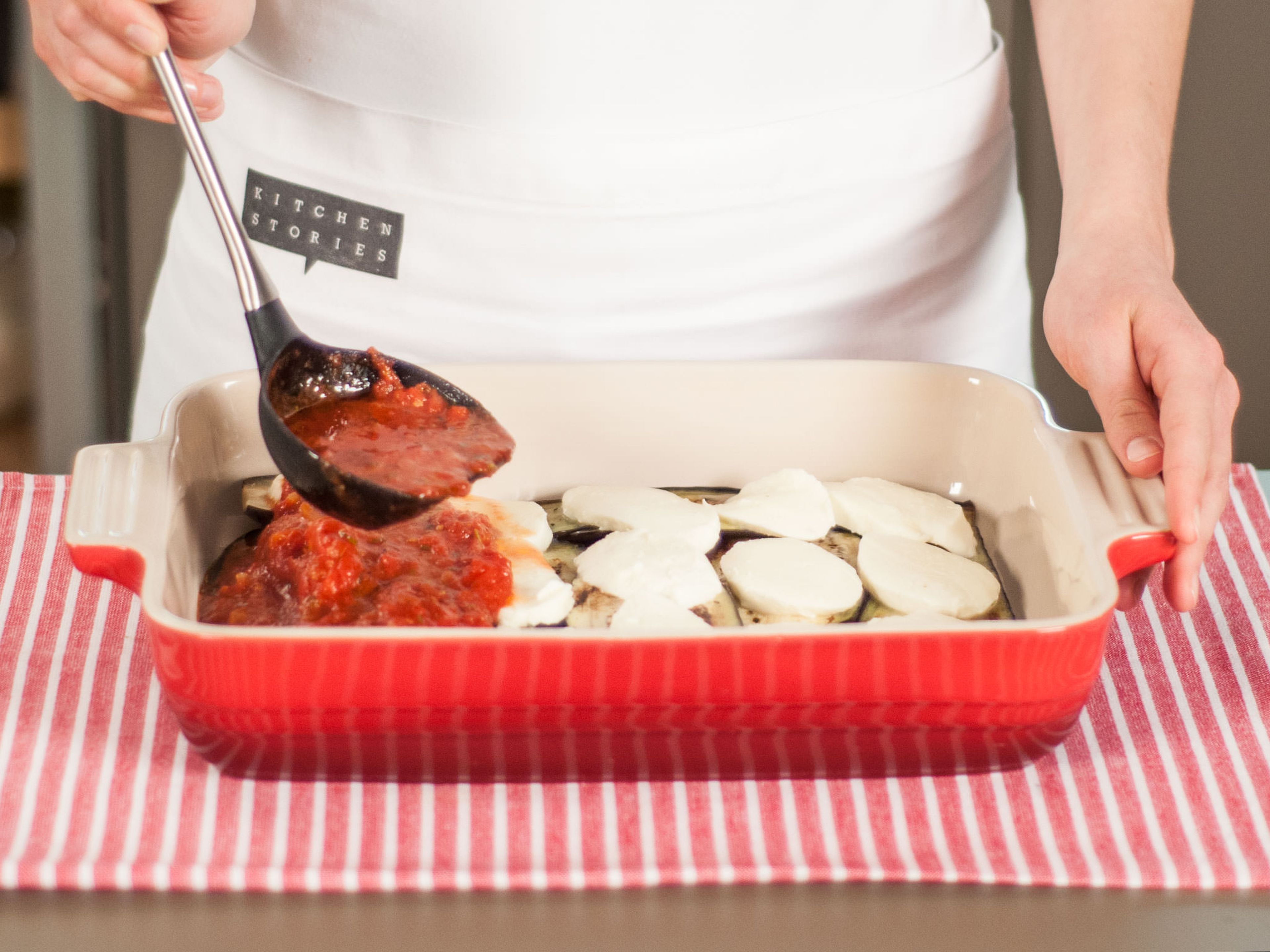 In a baking dish, create two separate layers of eggplant, mozzarella, and tomato sauce.