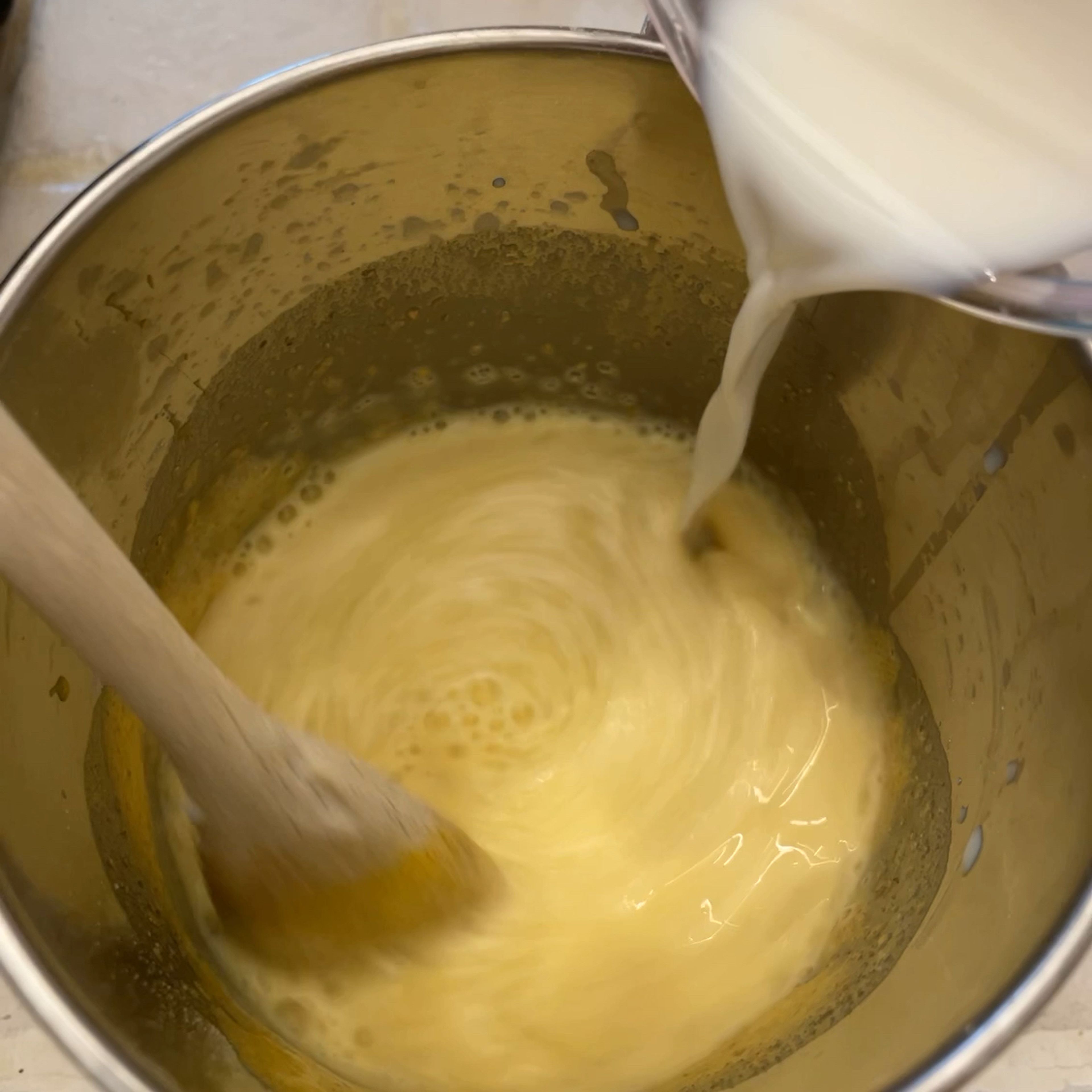 To prepare the filling cream (steps 5-7) we’ll first make a lemon custard cream and then add some whipped cream. Start by adding 3 egg yolks and 3 table spoons of sugar to a saucepan and mix them until obtaining a soft cream. Then add 3 table spoons of flour and keep mixing. Slowly add the milk while continuing to mix all ingredients. Finally add the lemon zest (the more, the better!).