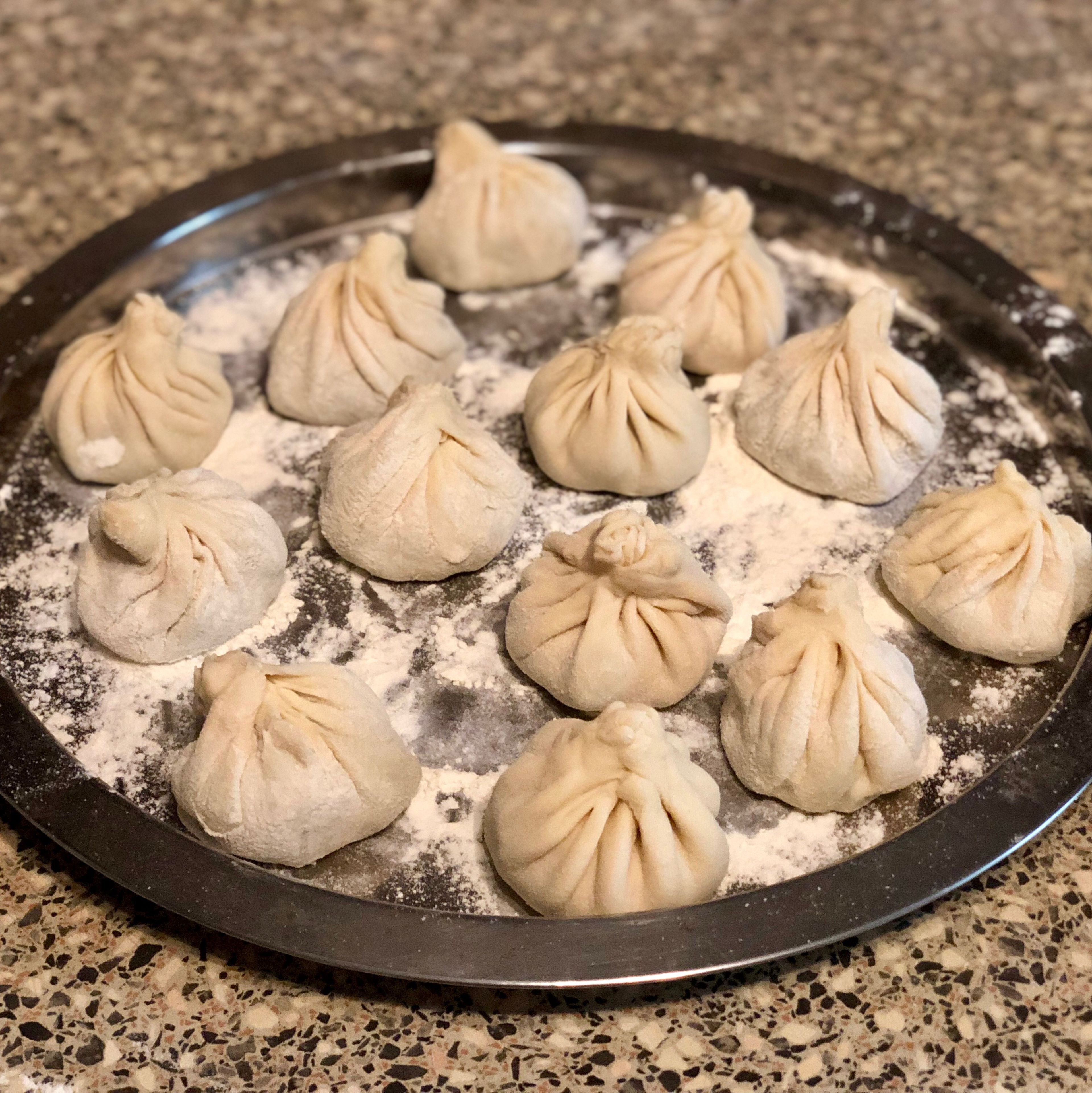Place finished dumplings on a  lightly floured tray and cover with a kitchen towel. 