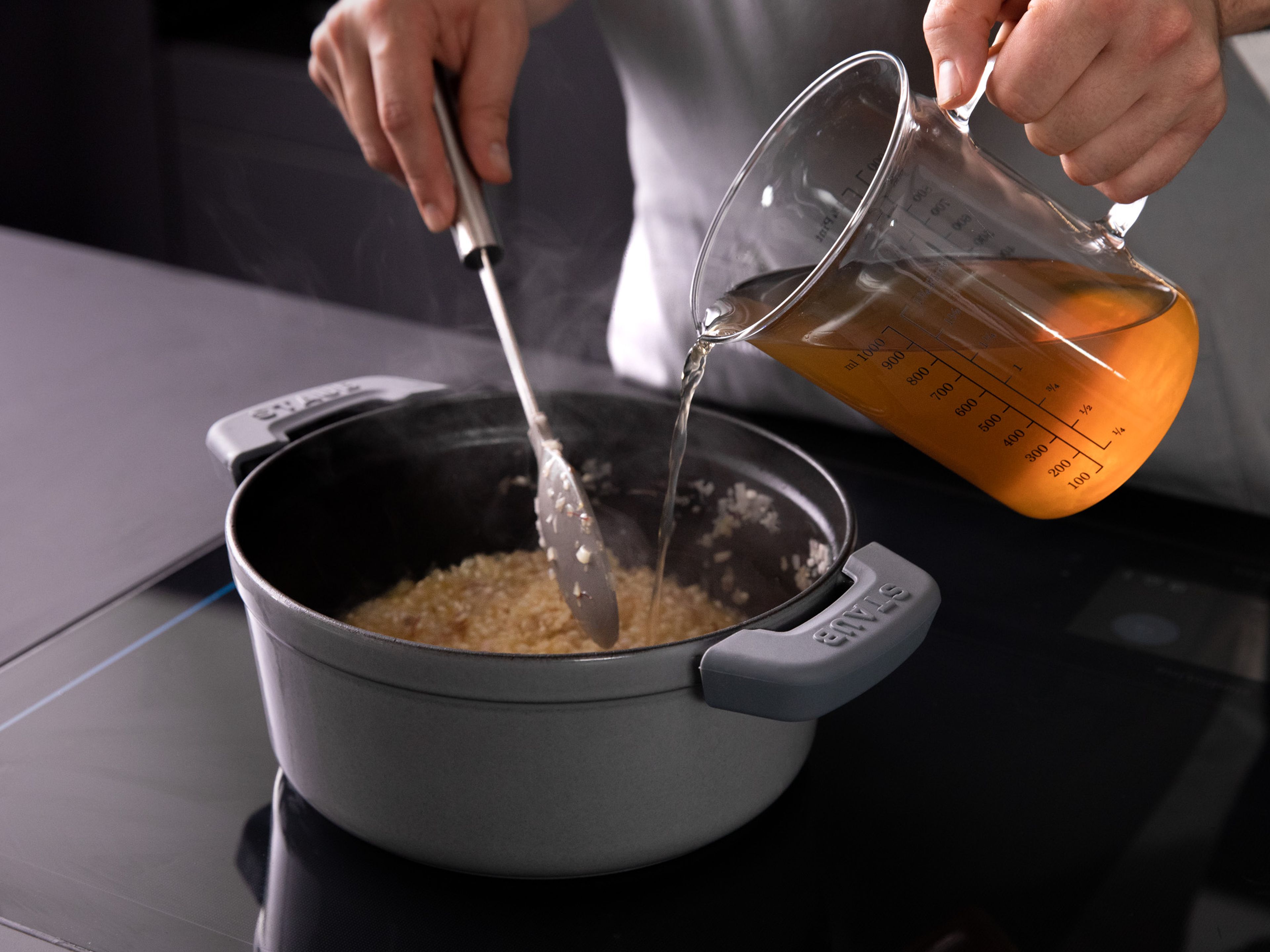 Deglaze with white wine. Stir continuously until risotto has fully absorbed wine. Add one-third of the beef stock to the pot and stir until fully absorbed. Repeat this process twice with the remaining beef stock. Cook, stirring constantly, until risotto is creamy but rice is still al dente, approx. 18–20 min.