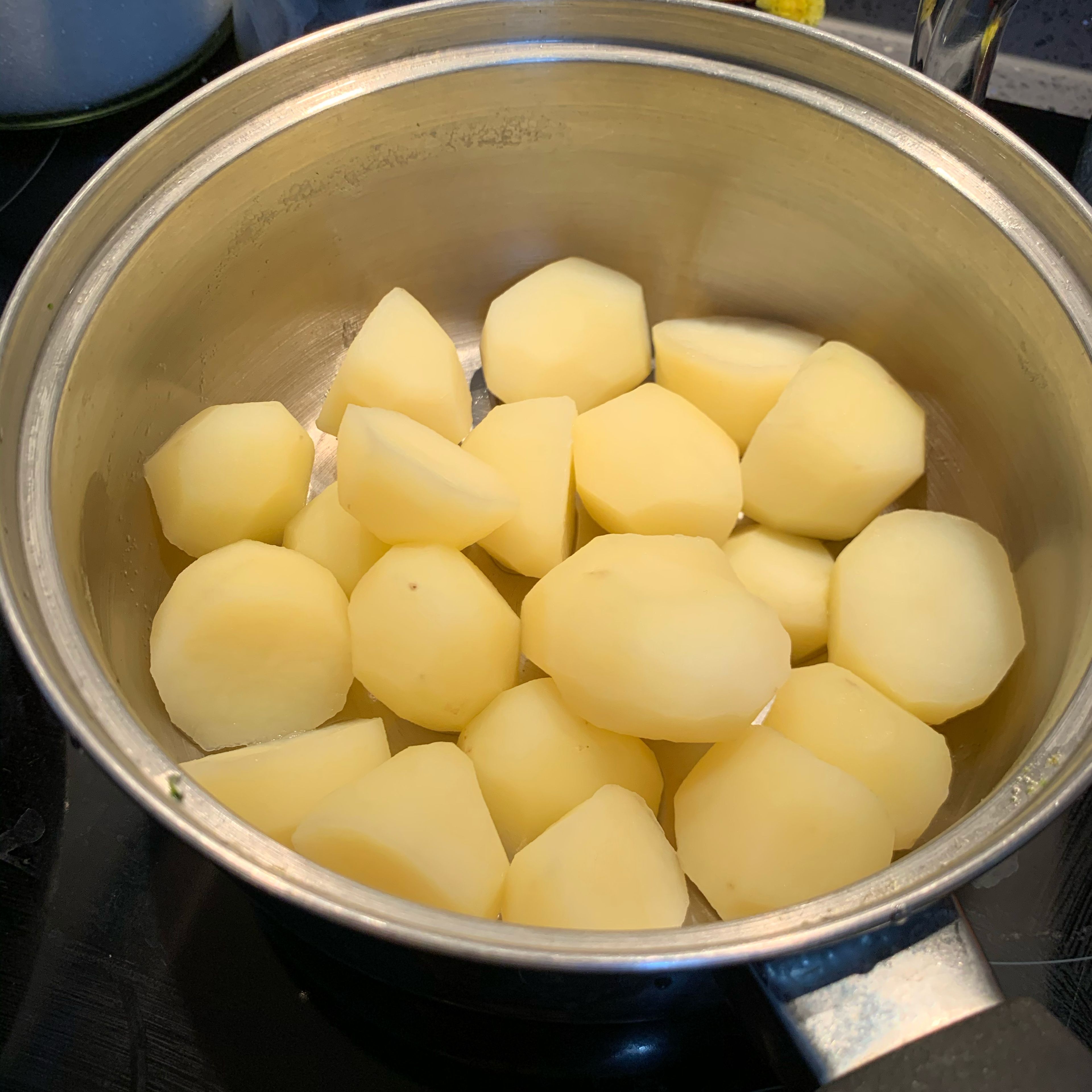 Prepare the baby potatoes by pealing them and cooking in a pan of water for about 10 minutes till nice and soft inside. Once they are done, take the water out and leave them in the warm pan. For a better taste, put some salt and butter at this stage so it melts.