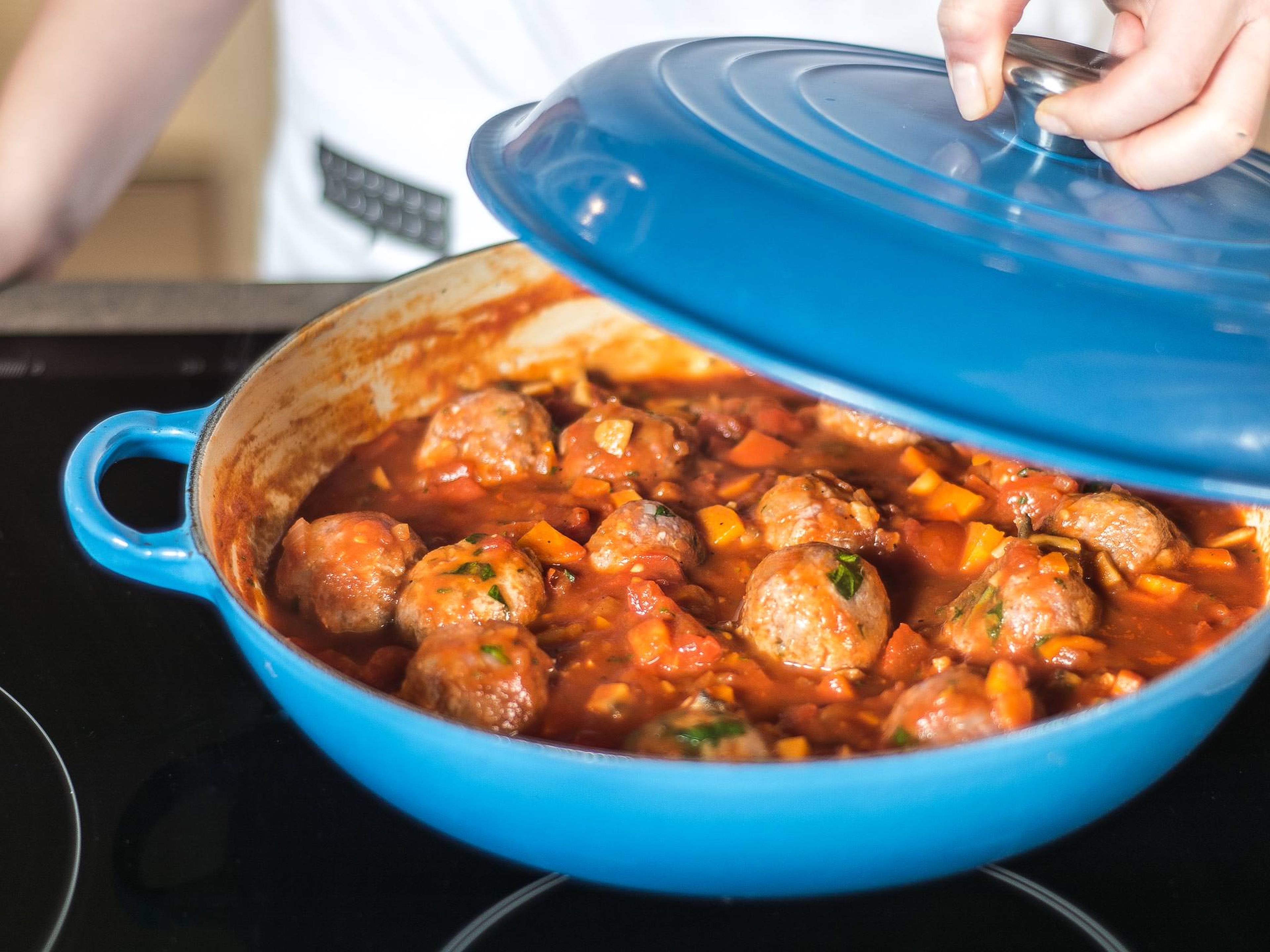 Next, add chopped herbs and meatballs to the tomato sauce and simmer for approx. 10 – 15 minutes with closed lid until the meatballs are cooked. Serve with rice or toasted bread.