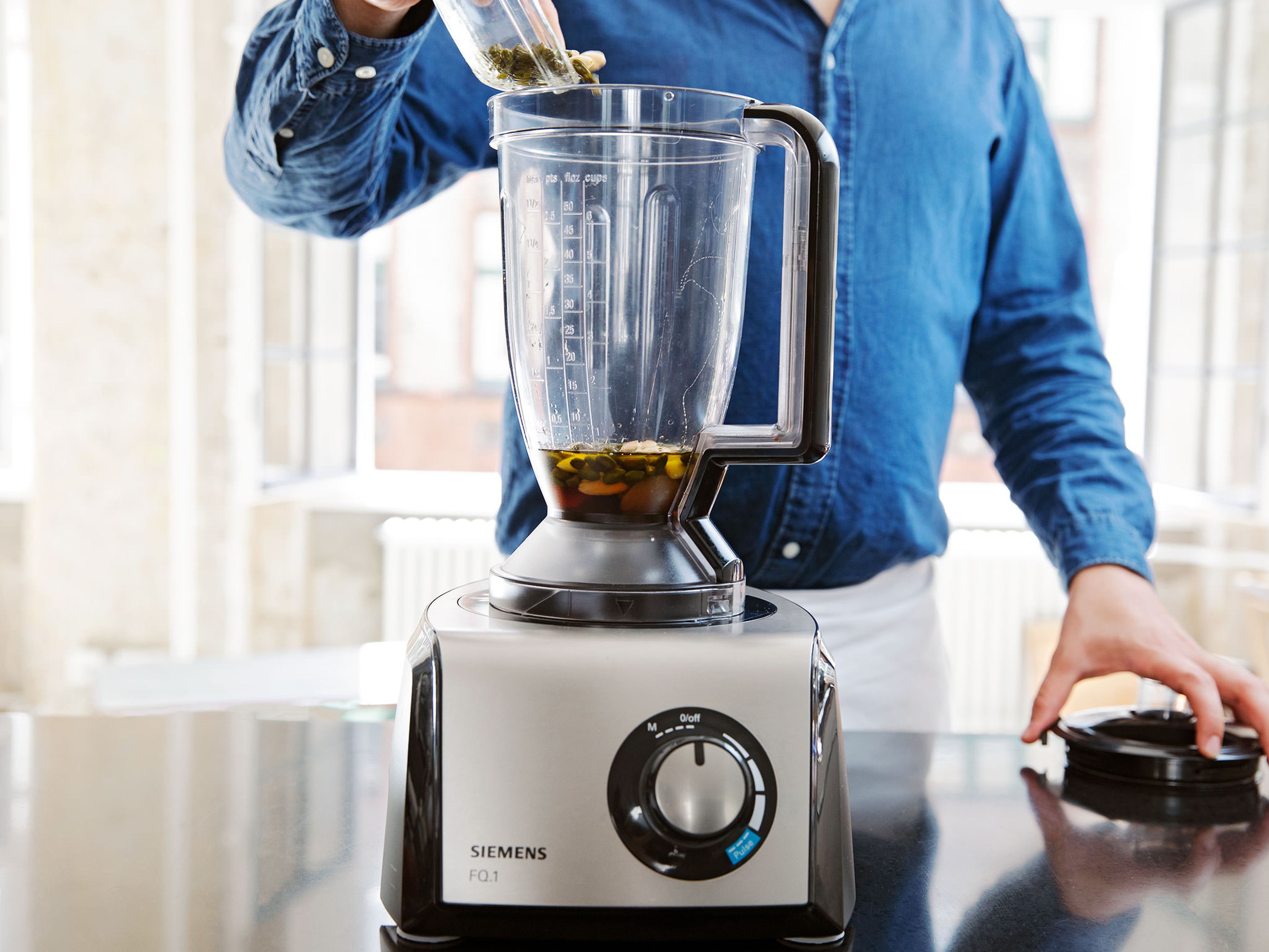 In a food processor, process the toasted nuts together with some more olive oil, dried apricots, amaretto, and half of the honey, until nuts are ground and mixture forms a coarse paste.