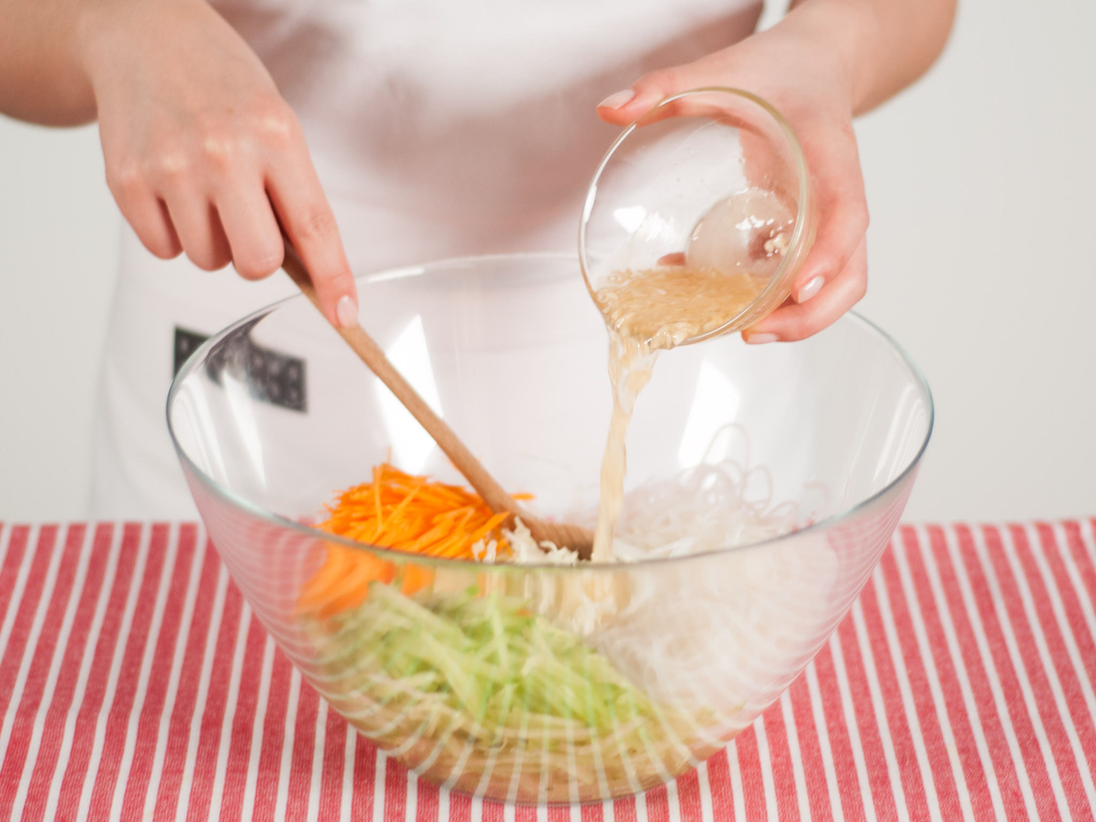 In a large bowl, combine cucumber, carrots, Chinese cabbage, and glass noodles. Add dressing and mix well.