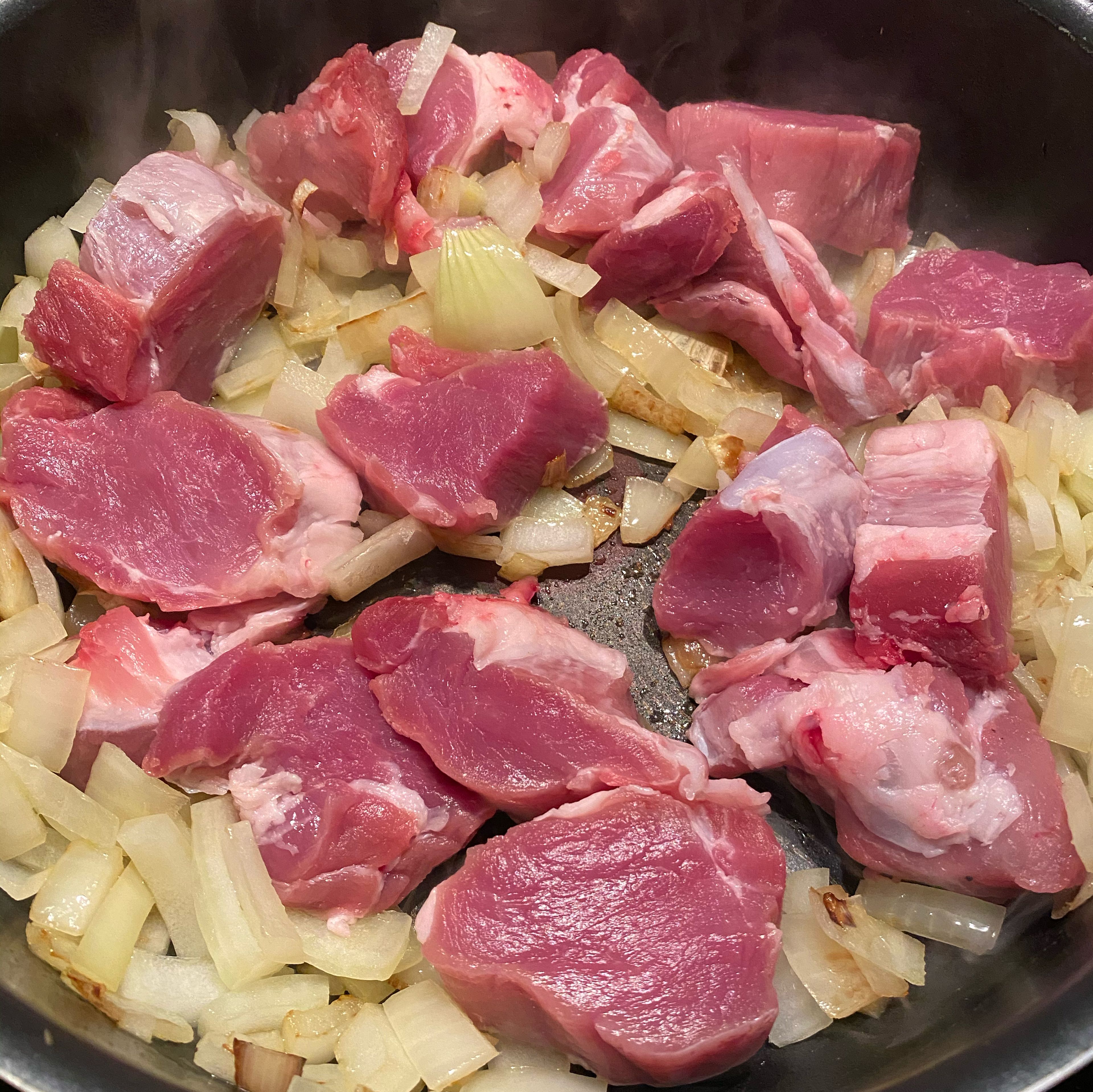Add the meat to the onions when they start becoming tender and brown, cook for a couple of minutes on each side so the meat gets brown