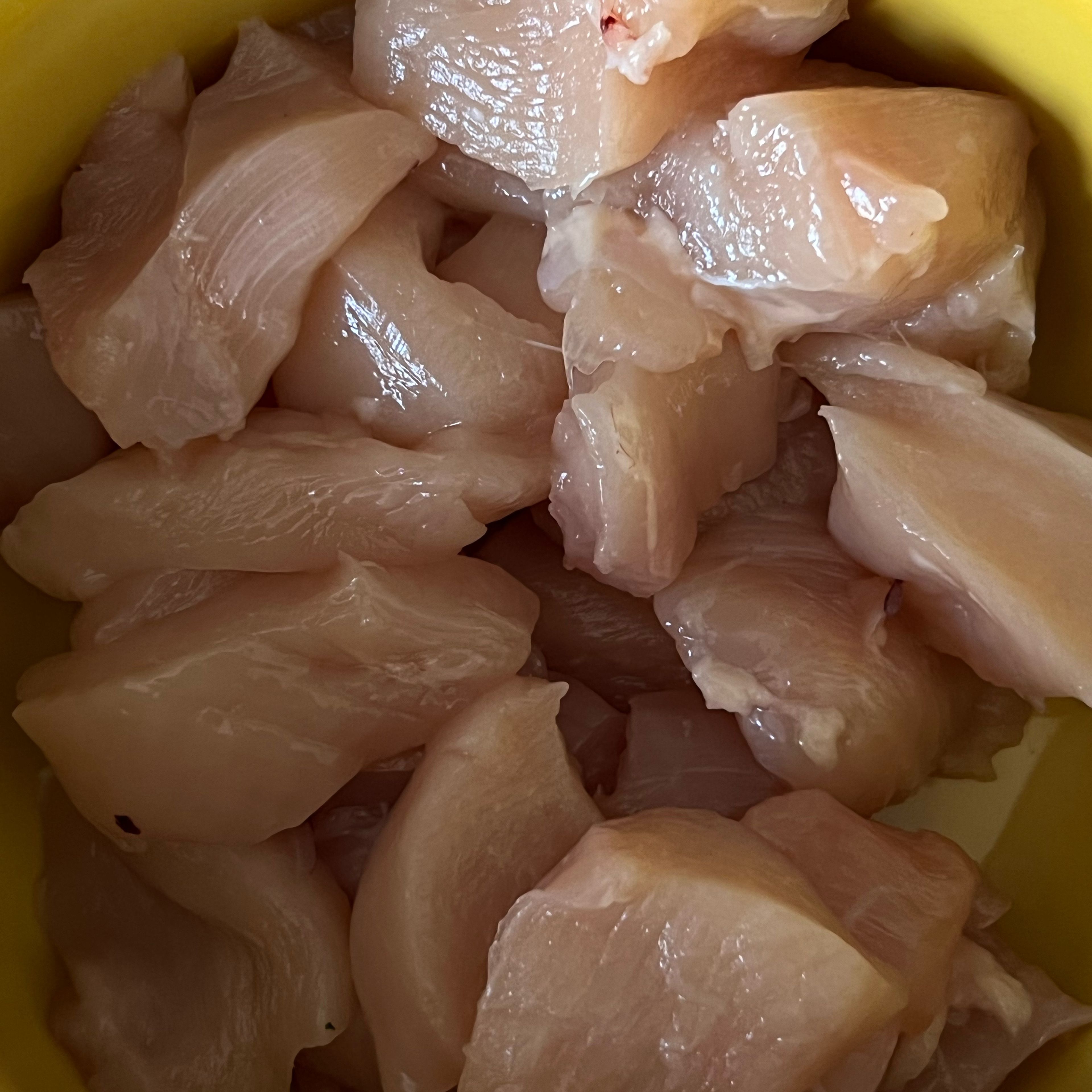 Cut your two slices of chicken into cubes and place them in a separate bowl.