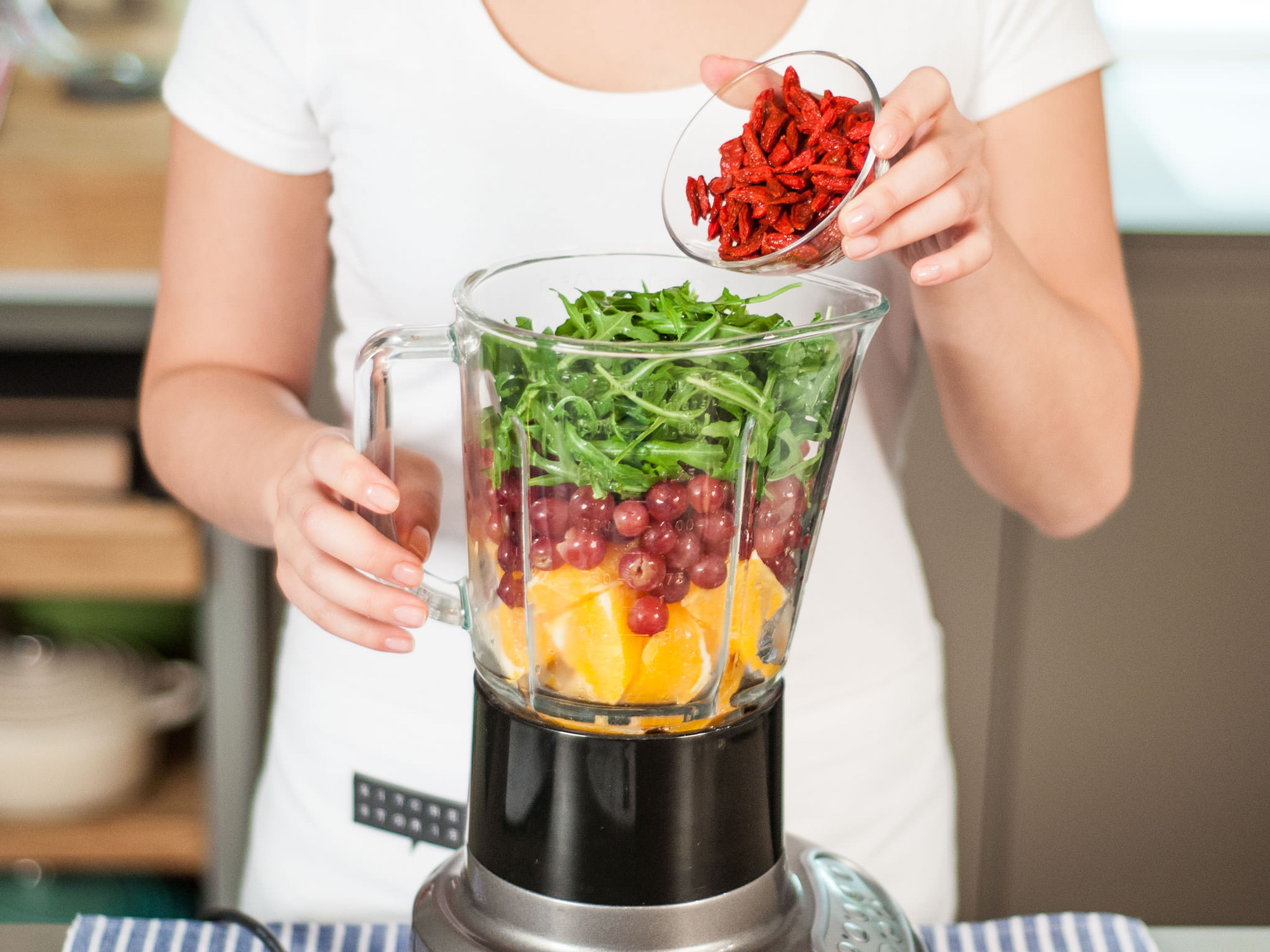 Add bananas, oranges, grapes, arugula, water, ice cubes, and berries to blender. Blend on high for approx. 1 - 2 min. until well mixed. Add some honey for more sweetness, if desired. Enjoy as a snack or for breakfast!