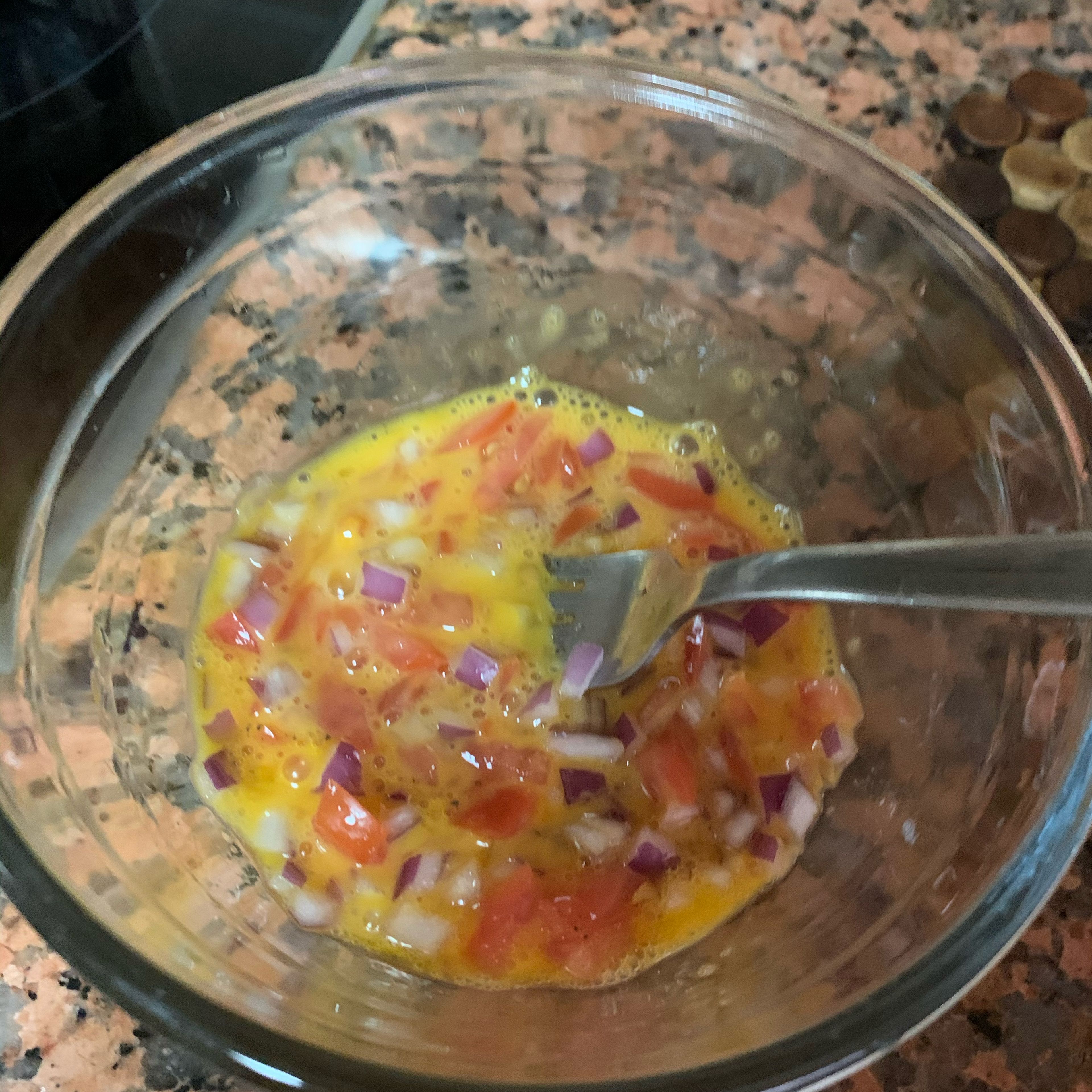 Add the tomato and onion into the whisked egg