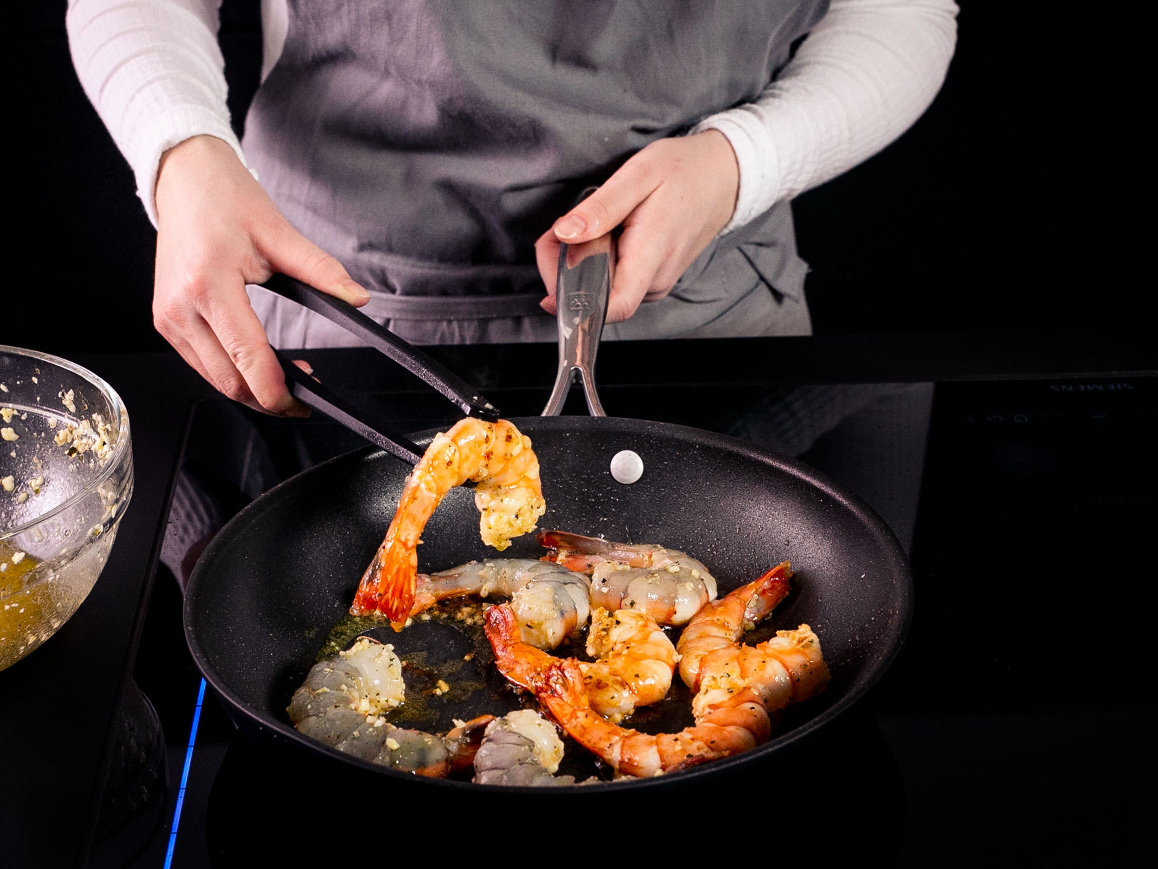 Set a pan over medium-high heat and bring up to temperature. Add a bit of vegetable oil, then fry shrimp until cooked through, approx. 3 min. per side. Once done, add the remaining mojo and toss together.