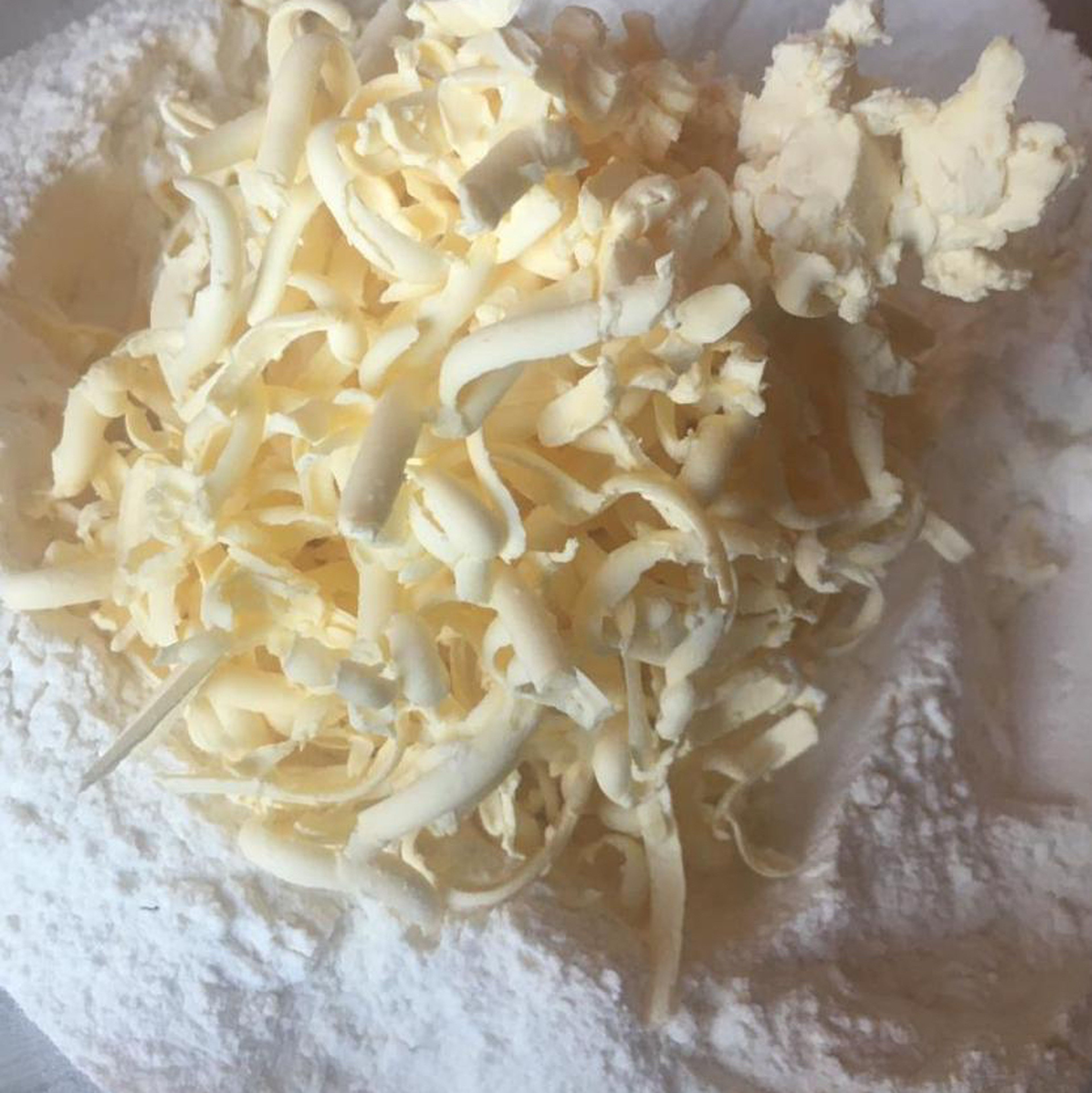 after we mix flour and egg yolks we need to add soft butter a pinch of salt ,100 g sour cream and 100 ml of warm water and mix either with hand or mixer with dough hook