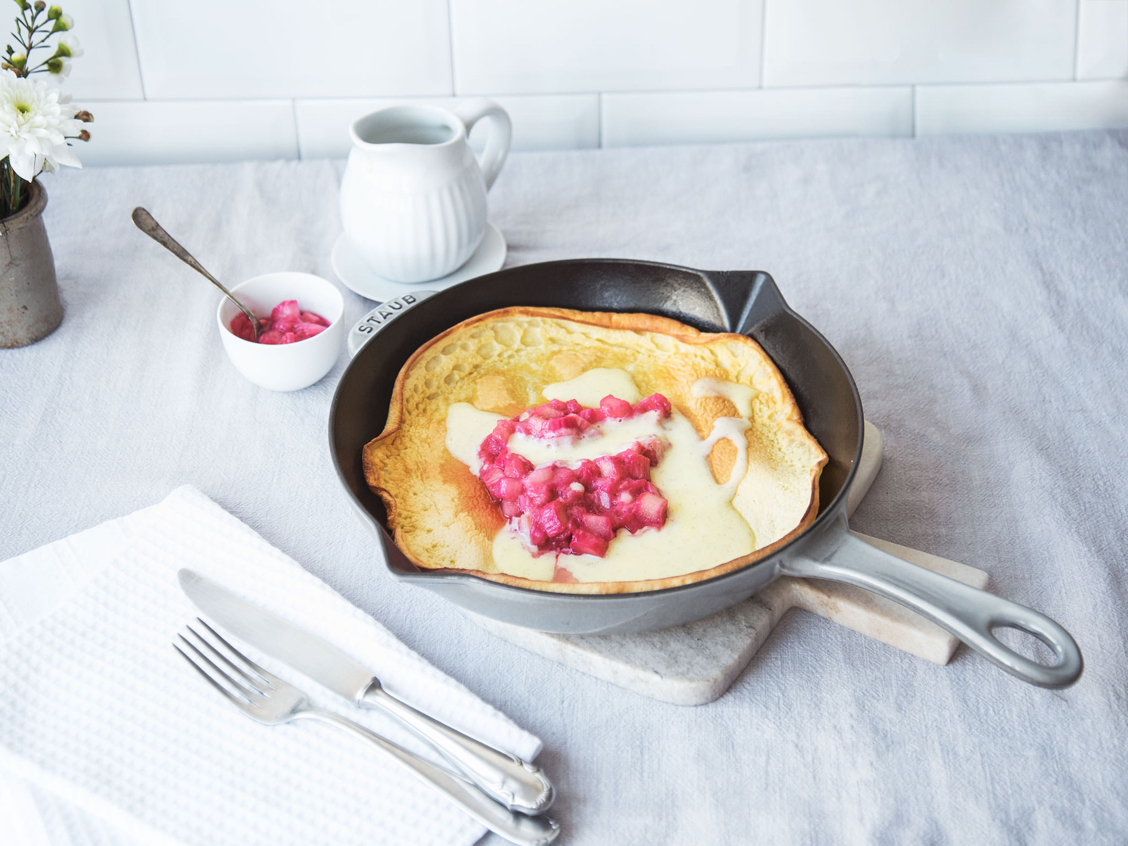 Rhubarb Dutch baby with vanilla sauce