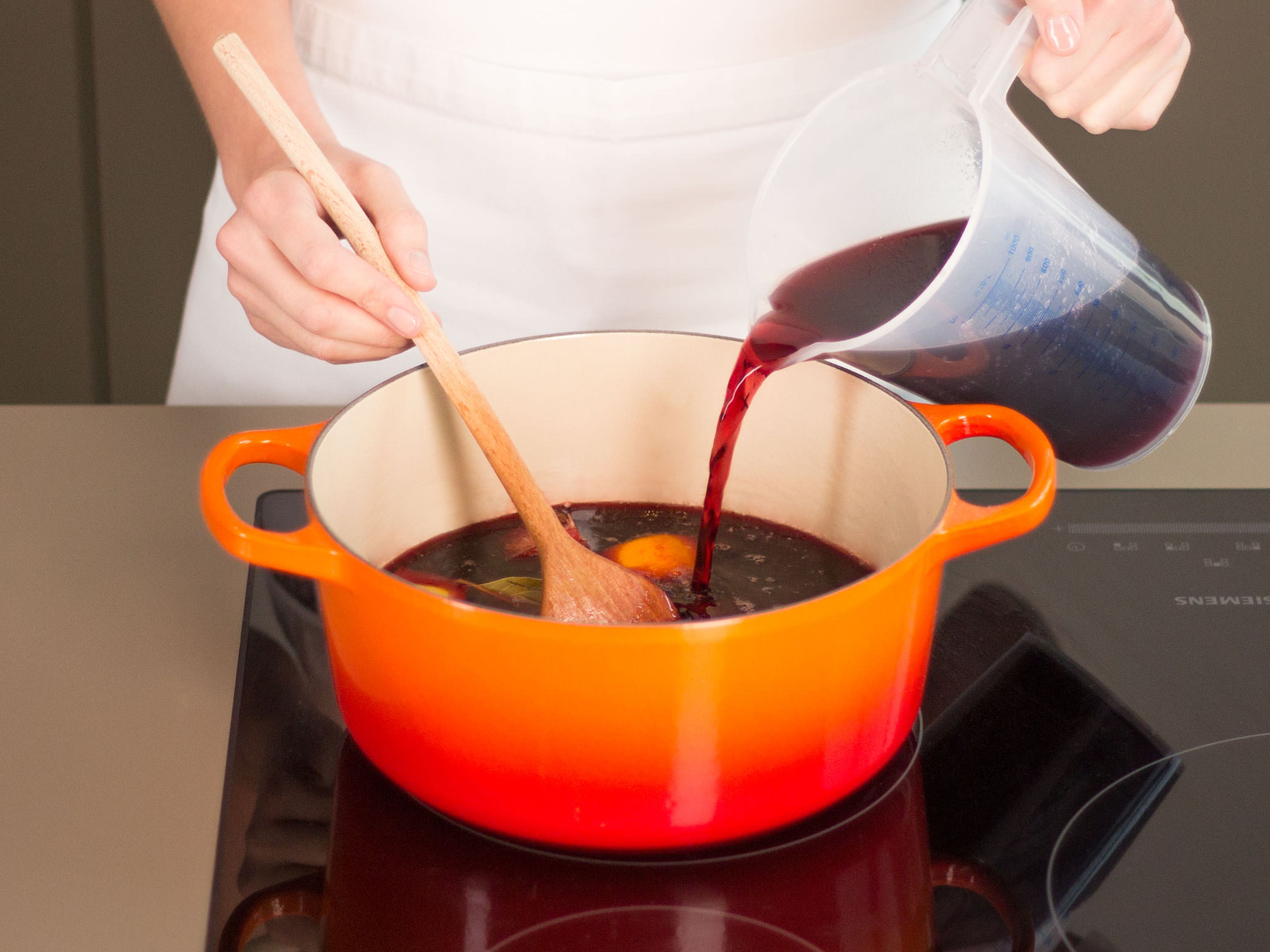 Add red wine, gently warming it up for approx. 5 min. Do not boil, as this would burn off the alcohol in the wine.