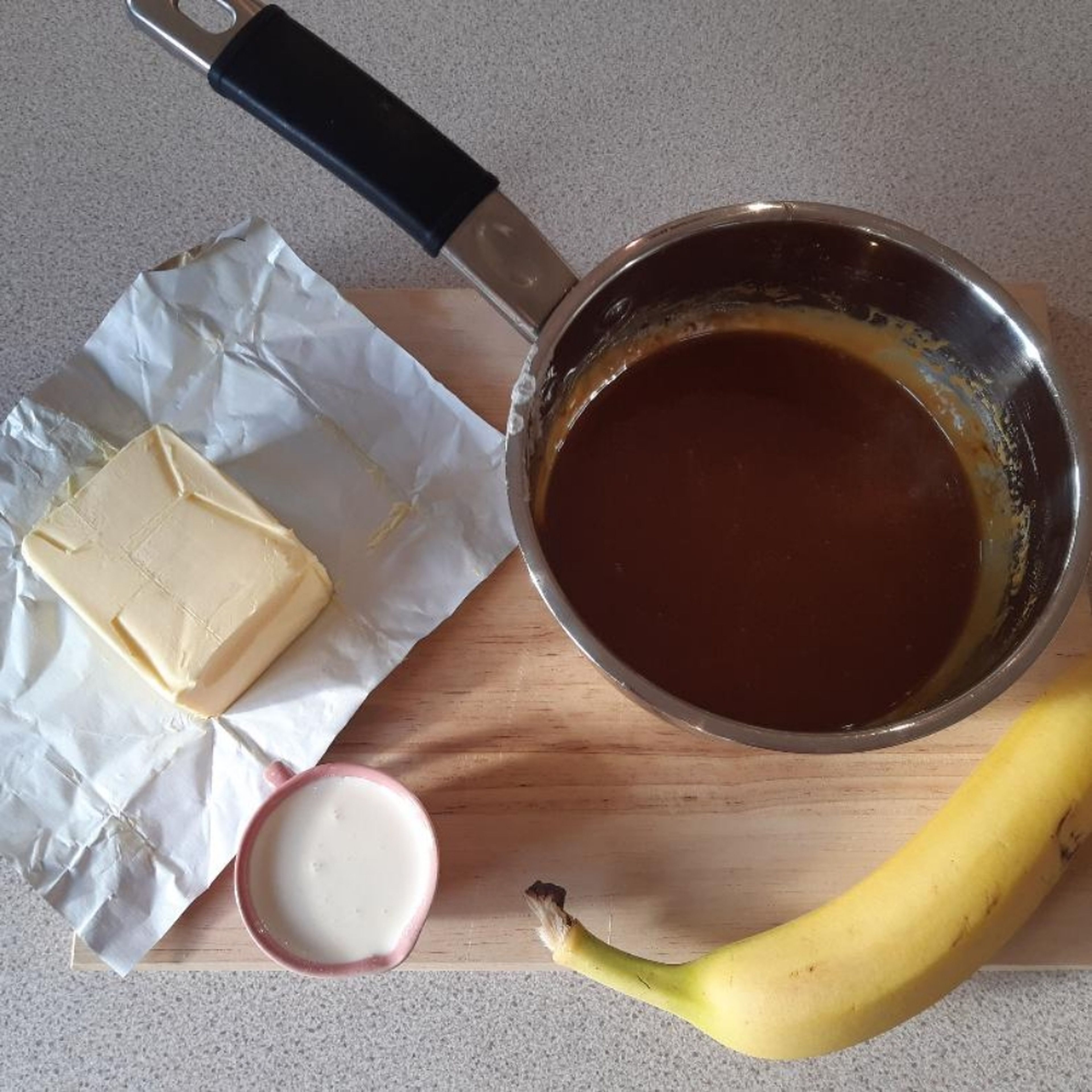 To make the caramel, place the sugar and water in the saucepan and allow the sugar to dissolve over a low heat. When dissolved, the sugar liquid will start to colour. When it reaches a light amber colour add the butter and whisk. Take the saucepan off the heat, whisk in the cream and add the rum. (Rum is optional)