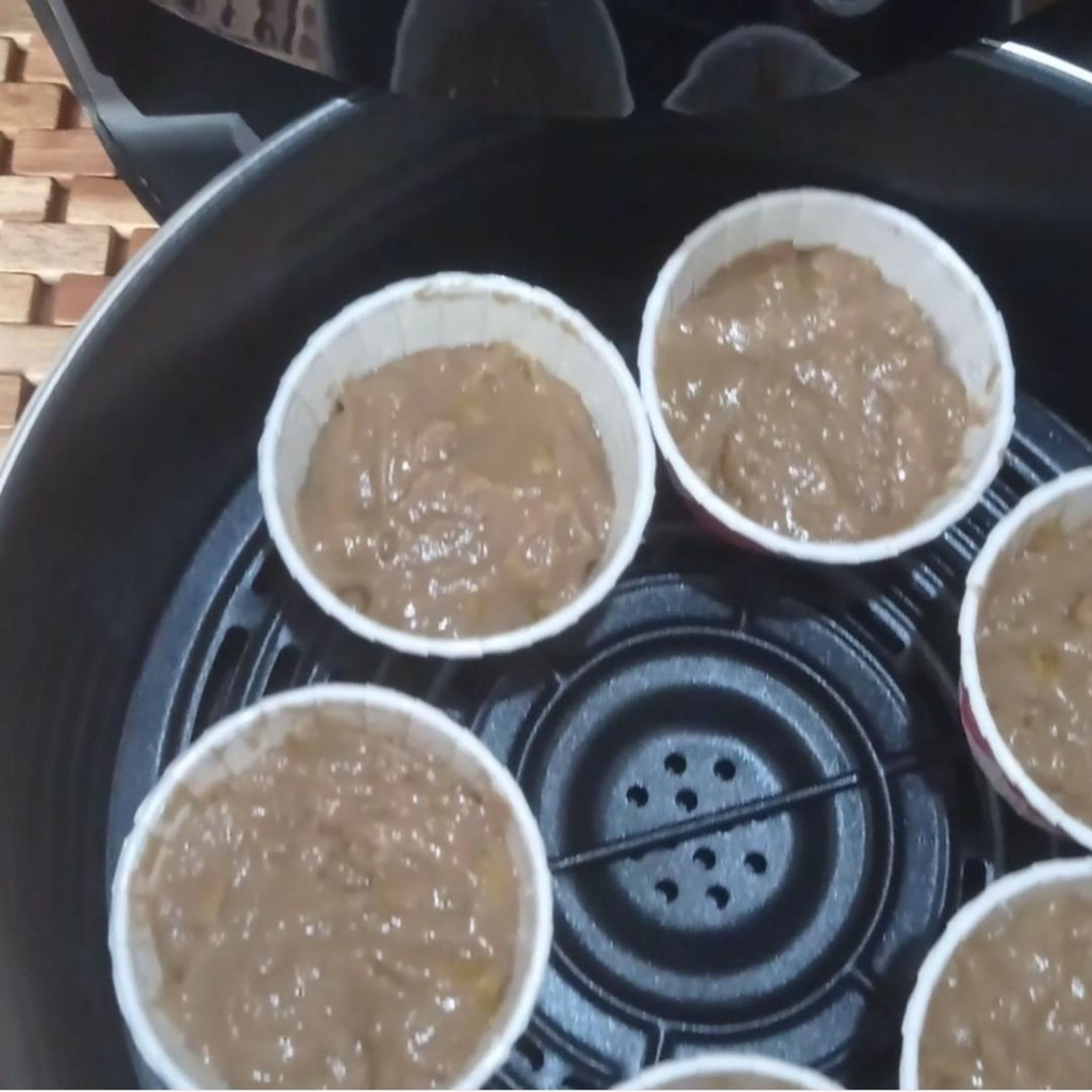 Pour the batter into the muffin cups. Transfer the muffin cups into the Air Fryer basket.