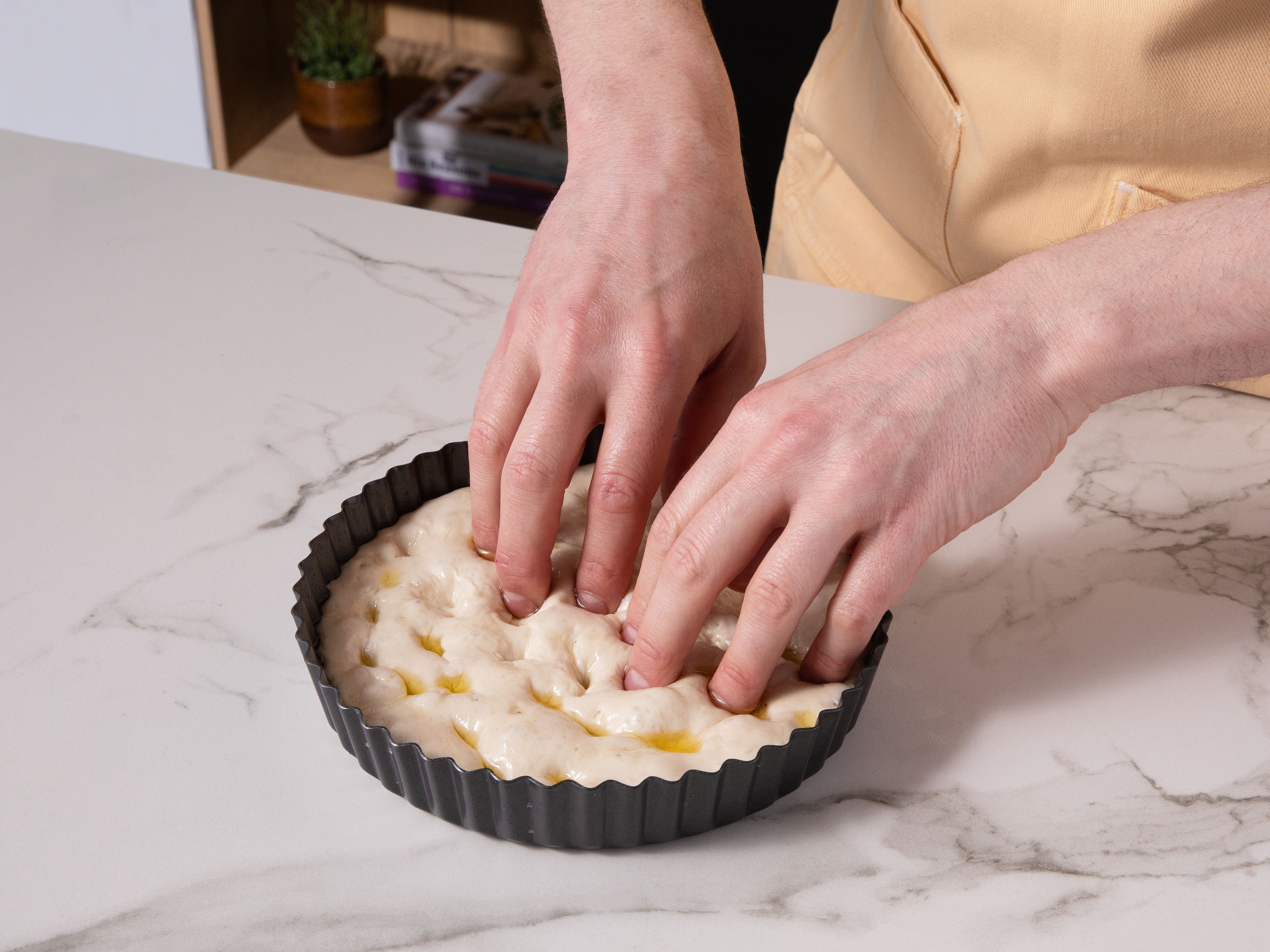 Once it is nearly doubled in size, preheat the air fryer to 180°C/356°F. Drizzle the dough generously with olive oil and dimple it with your fingers. Top with rosemary, or other ingredients as you wish and bake for approx. 15 min. Once it’s golden brown at the top, remove from the air fryer and serve as you wish.