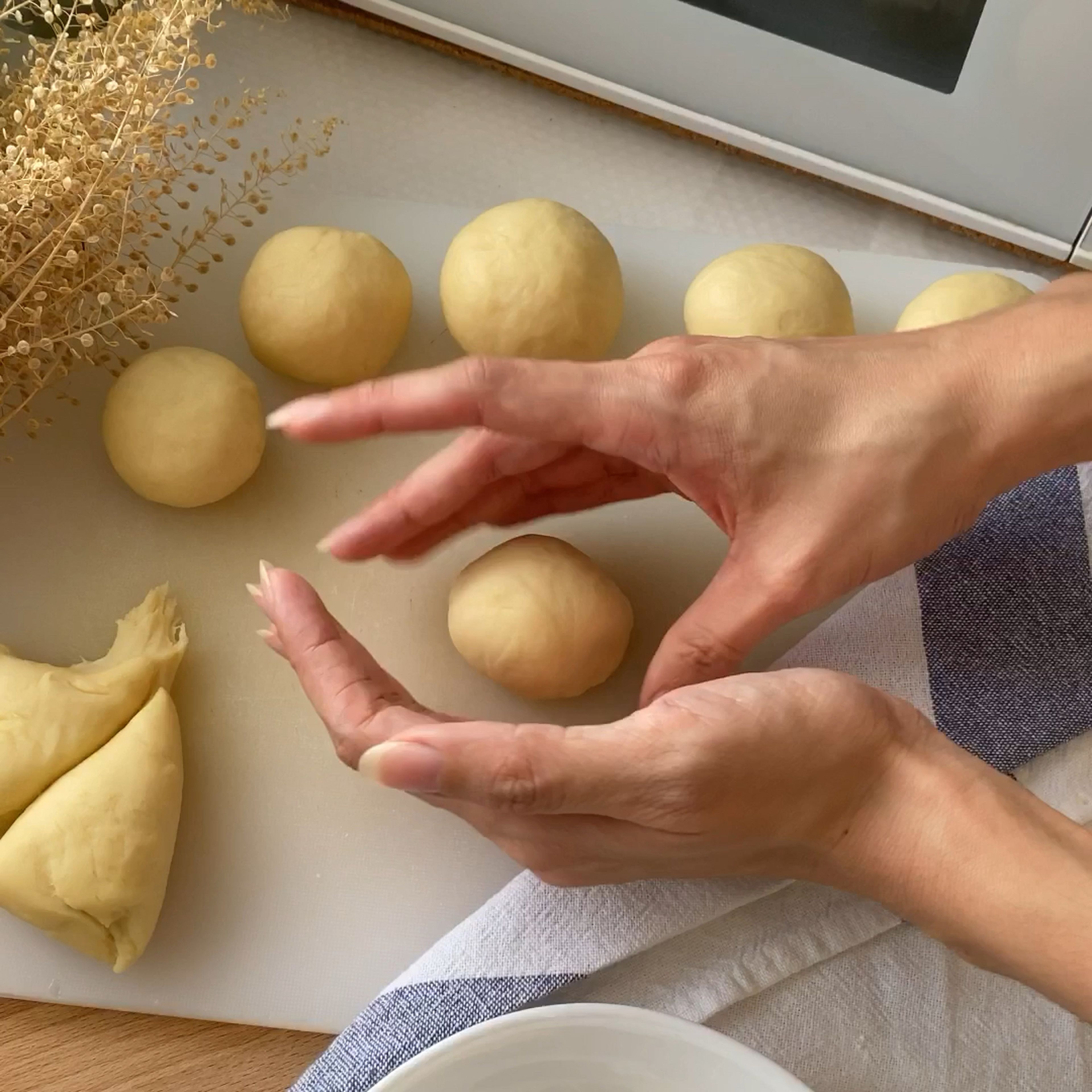 After 30 minutes, divide dough and fill with chocolate or cheese. Roll them into balls, cover and let rest for another 45 minutes.