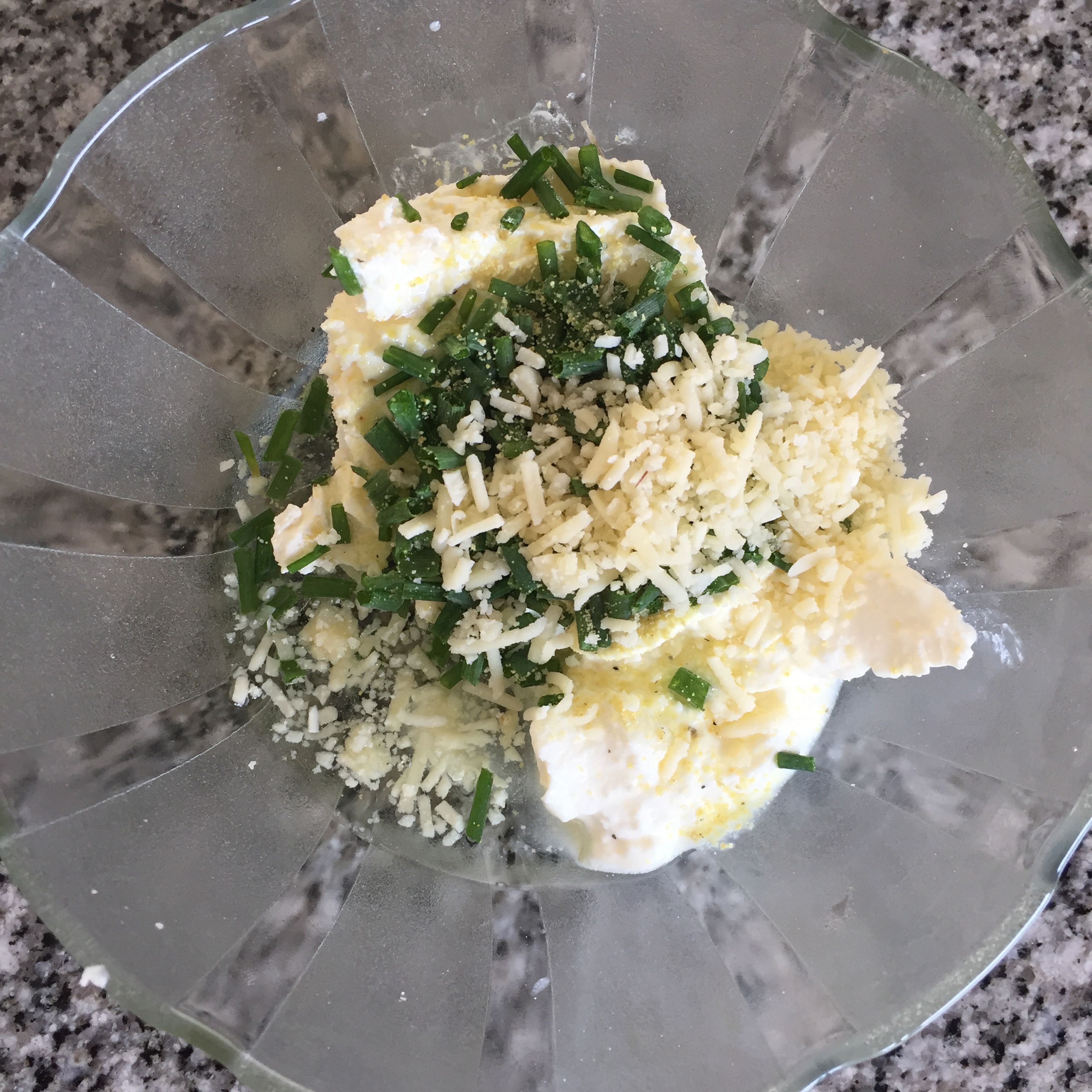 in a bowl, combine cream cheese, chives, shredded parmesan and oil, and stir until creamy.